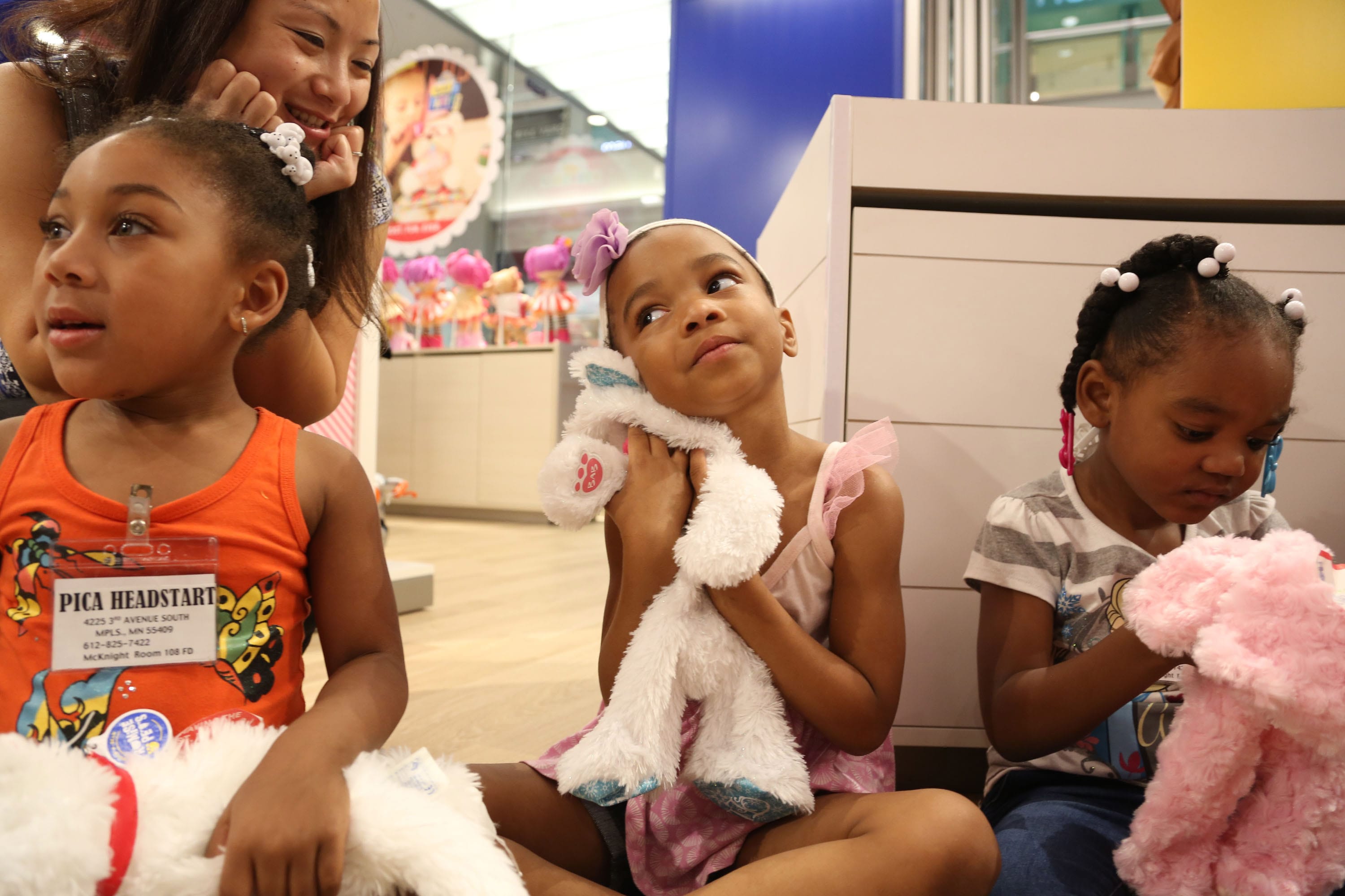 Shamajah Rogers, 4, hugs her stuffed cat as she waits for her animal to be stuffed along with the rest of her group from PICA Head Start in Minneapolis at the newly redesigned Build-a-Bear at the Mall of America before its grand reopening on Sept. 1, 2015 in Bloomington, Minn. This group of kids were one of the first that day to have a bear made.