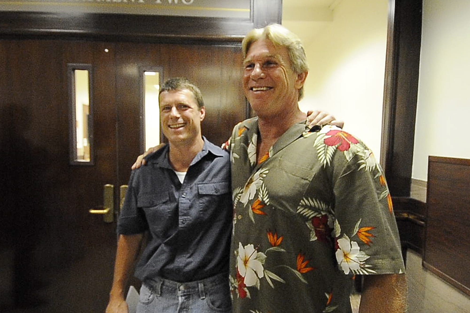 Alan Northrop, left, and Larry Davis celebrate in July 2010 outside a Clark County courtroom after a Superior Court judge dismissed charges against them in a 1993 rape conviction on the basis of new DNA evidence that pointed to different assailants.
