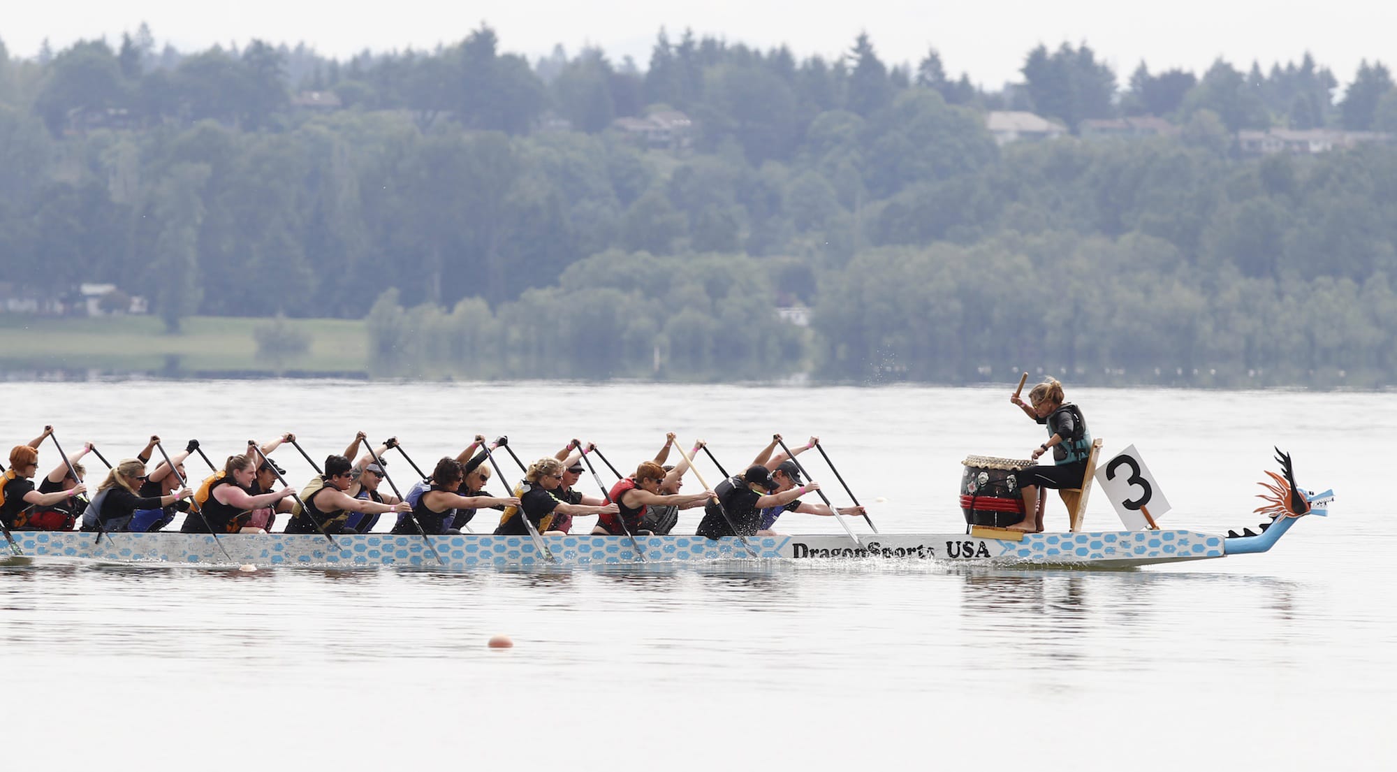 Participants near the finish line Sunday at the Paddle for Life dragon boat festival at Vancouver Lake.