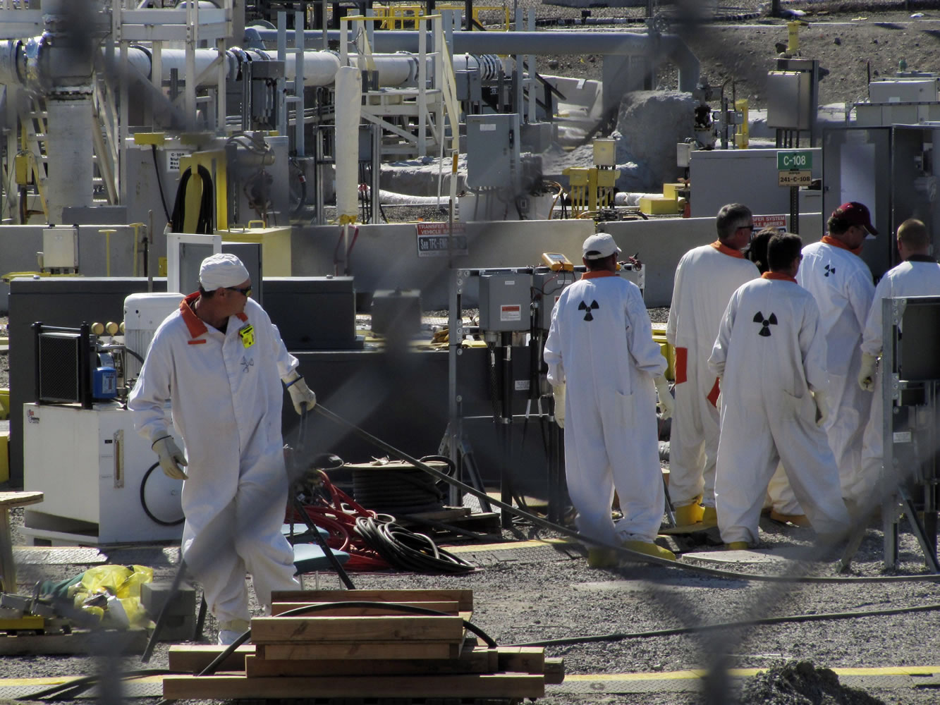 Technicians work at a Hanford nuclear reservation tank farm, where highly radioactive waste is stored underground, in July 2010.