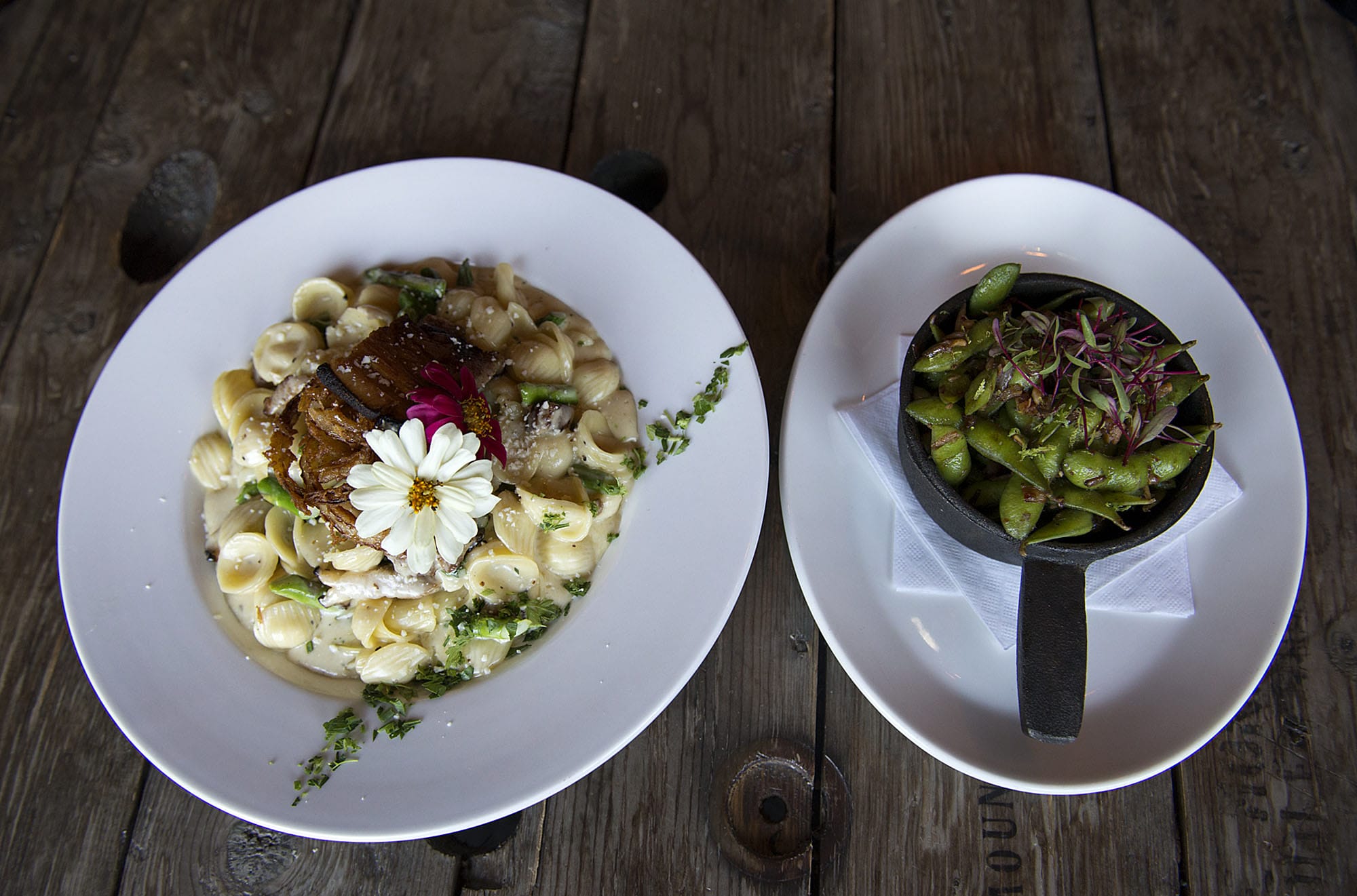 A plate of adult mac and cheese, left, is seen next to roasted edamame at Barrel Mountain Brewery in Battle Ground on Friday afternoon, Sept. 18, 2015.
