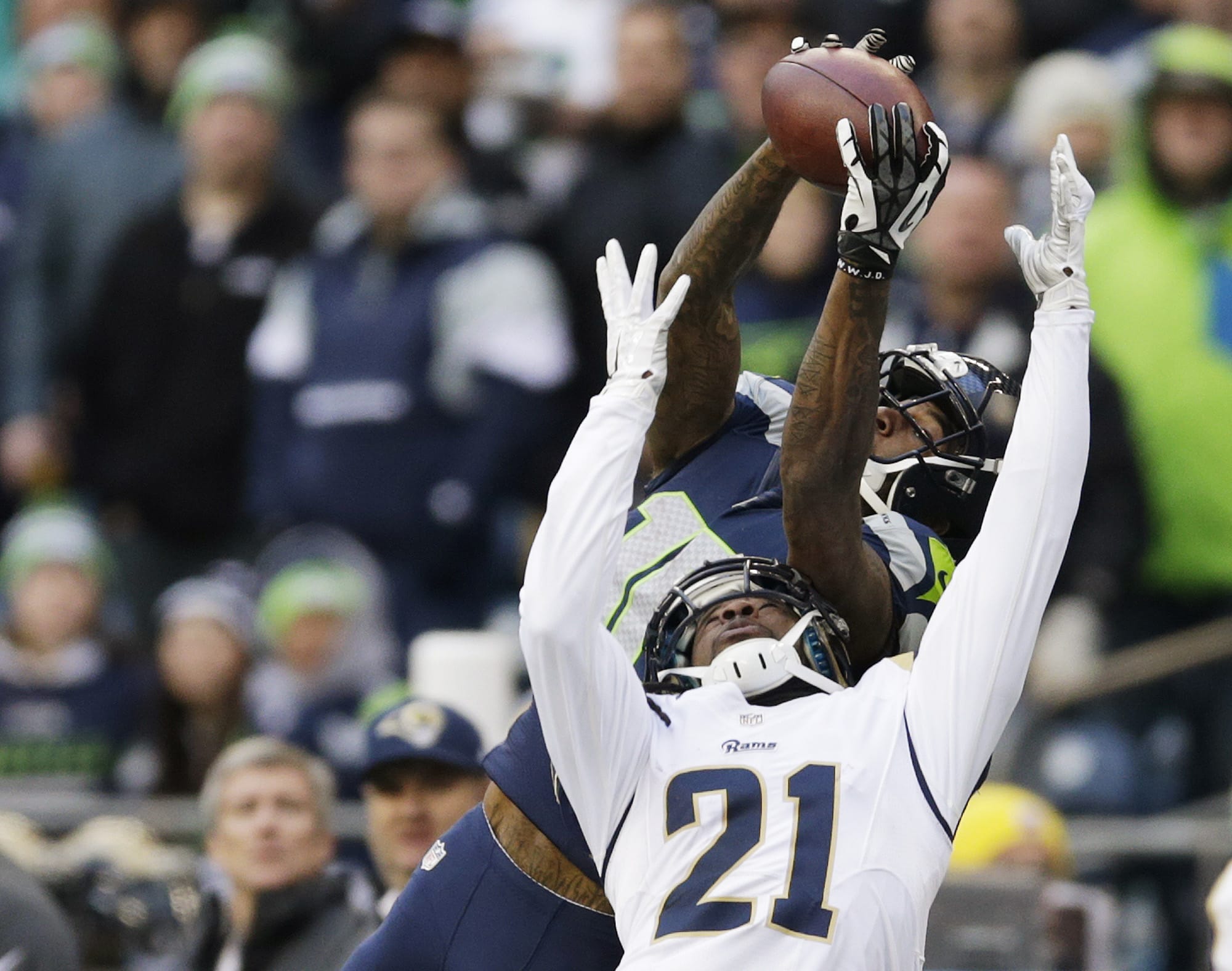 Seattle Seahawks wide receiver Paul Richardson, top, makes a leaping reception against the defense of St. Louis Rams' Janoris Jenkins (21) in the second half Sunday, Dec.