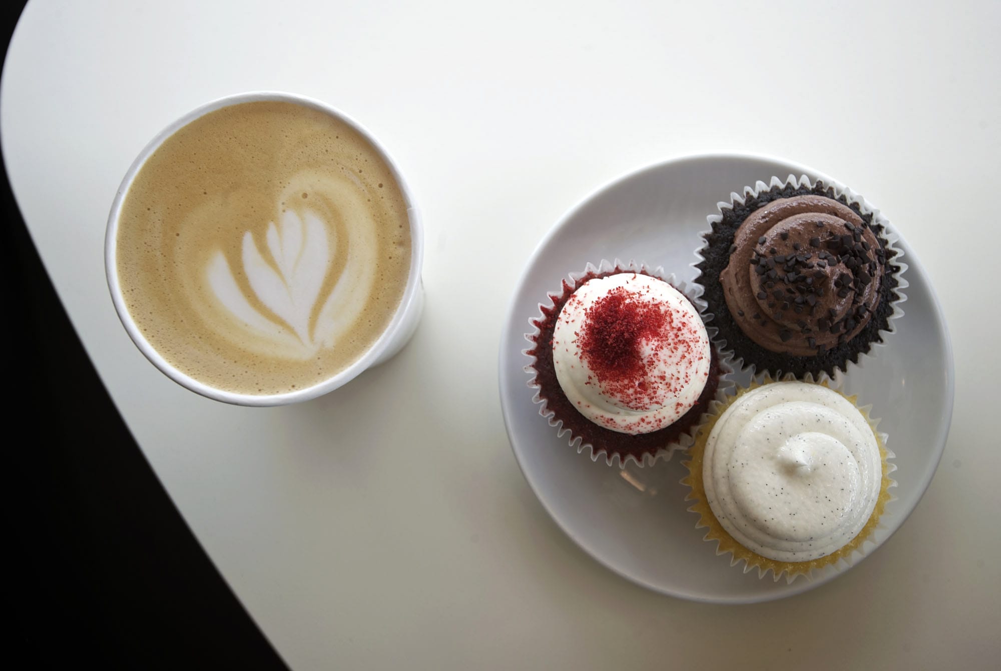 A double-shot latte and assorted cupcakes are among the offerings at Cupidone Coffee House in Vancouver.