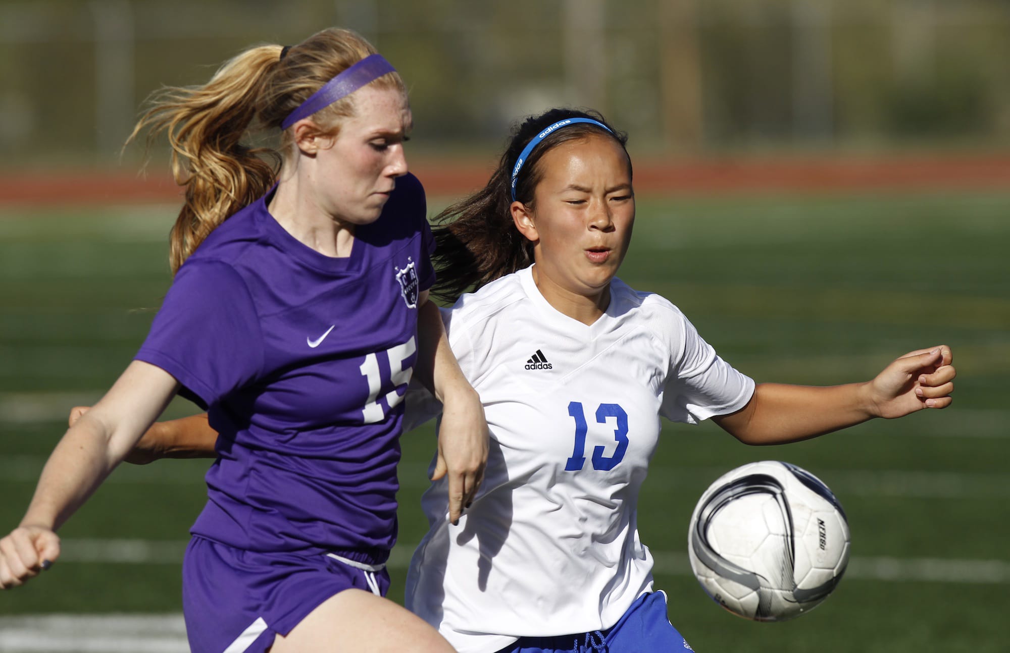 Mountain View's Lilah Favour (13) and Columbia River's Katie Anthony (15) battle for the ball in girls soccer.
