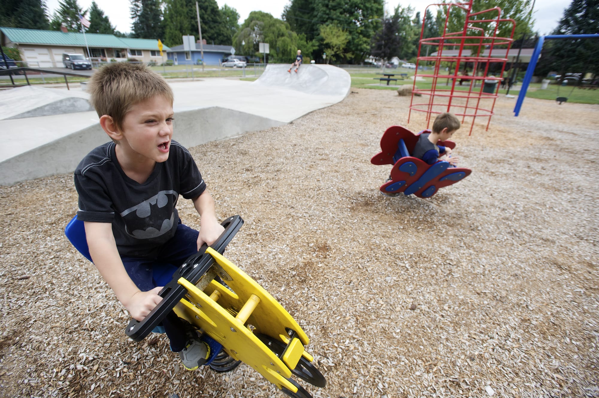 Nicholas Caruthers, 7, left, and Toby Caruthers, 10, both from Vancouver, play at the Yacolt Town Park.