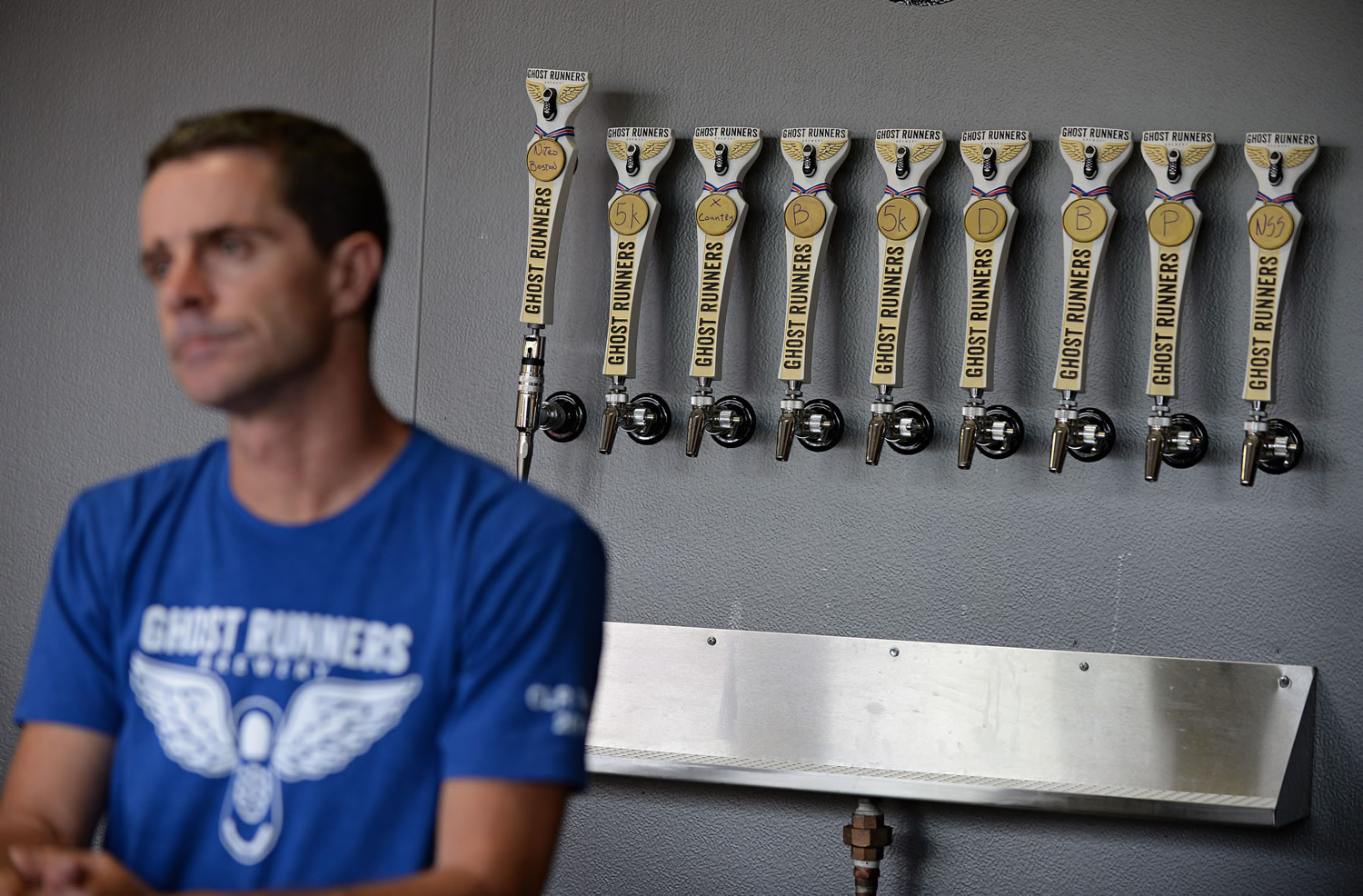 Co-owner Rob Ziebell offers a range of beers, all with running-related names, at Ghost Runners Brewery.