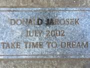 A marker placed in honor of Donald Jarosek at Esther Short Park.
