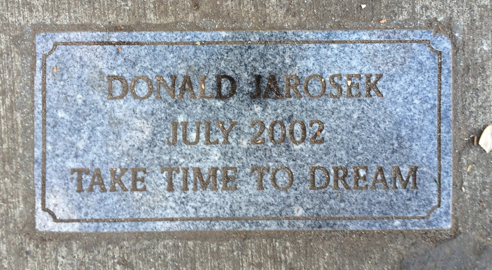 A marker placed in honor of Donald Jarosek at Esther Short Park.