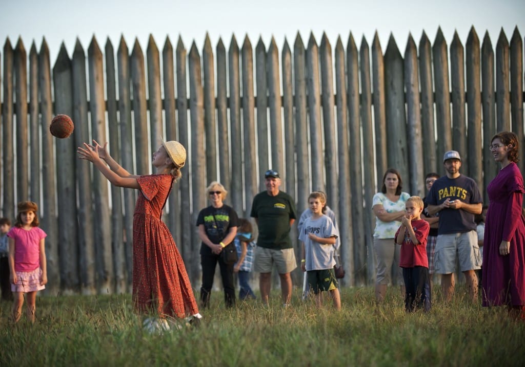 Eris Delay, 10, of Vancouver, plays with a ball while playing a villager for the 1840s during the Campfires and Candlelight event at Fort Vancouver National Historic Site in 2013. A new program, called Every Kid in a Park, encourages family visits to federally managed parks and attractions by giving fourth-graders a pass that allows family members to accompany them for free through Aug.