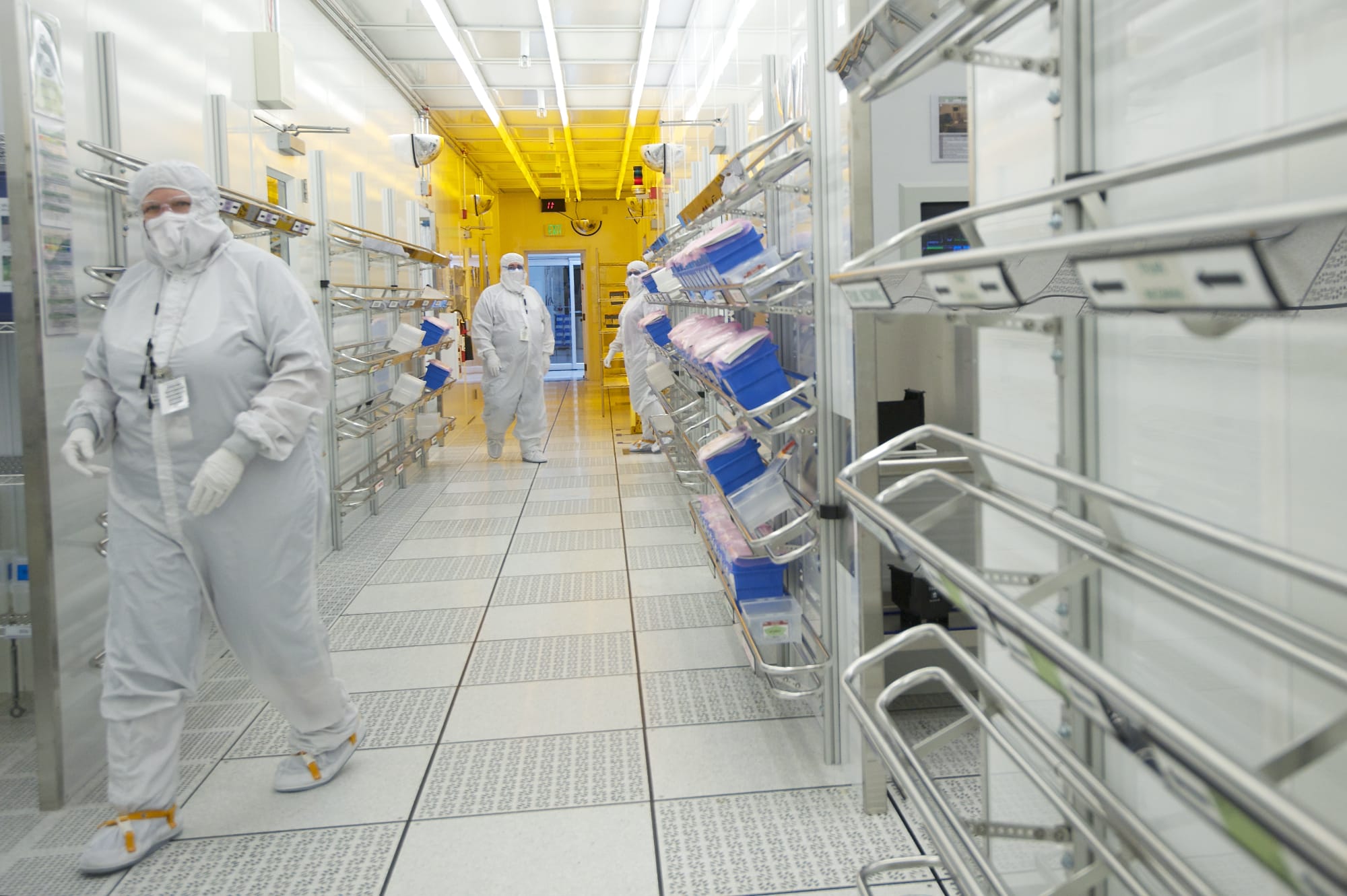 Linear Technology employees move through a corridor inside a clean room at the company's Camas manufacturing plant.