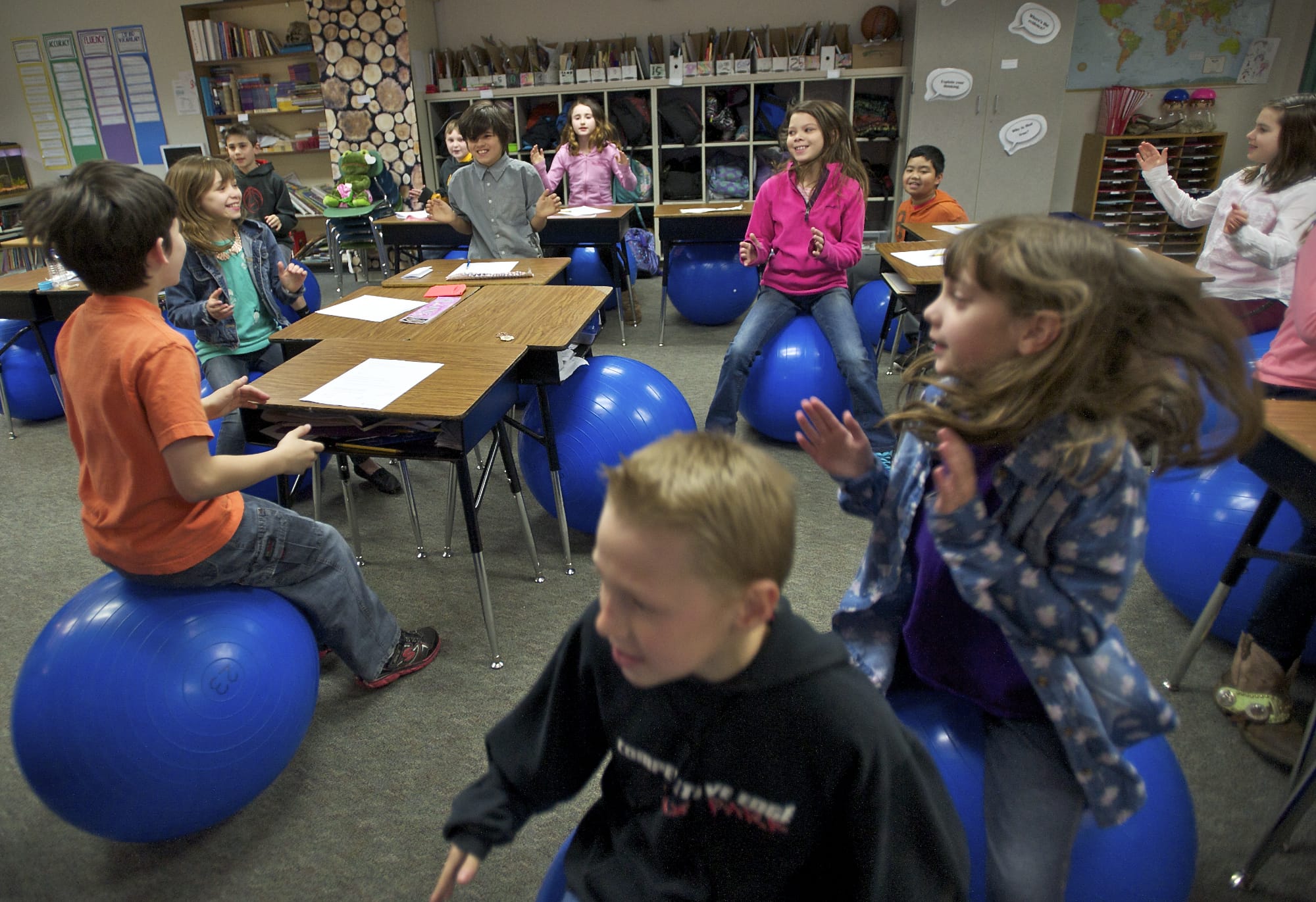 Alice Yang's fourth-grade students at Cape Horn-Skye Elementary School in Washougal bounce on stability balls while singing &quot;Nifty Fifty United States.&quot; Yang has incorporated the stability balls into her curriculum.