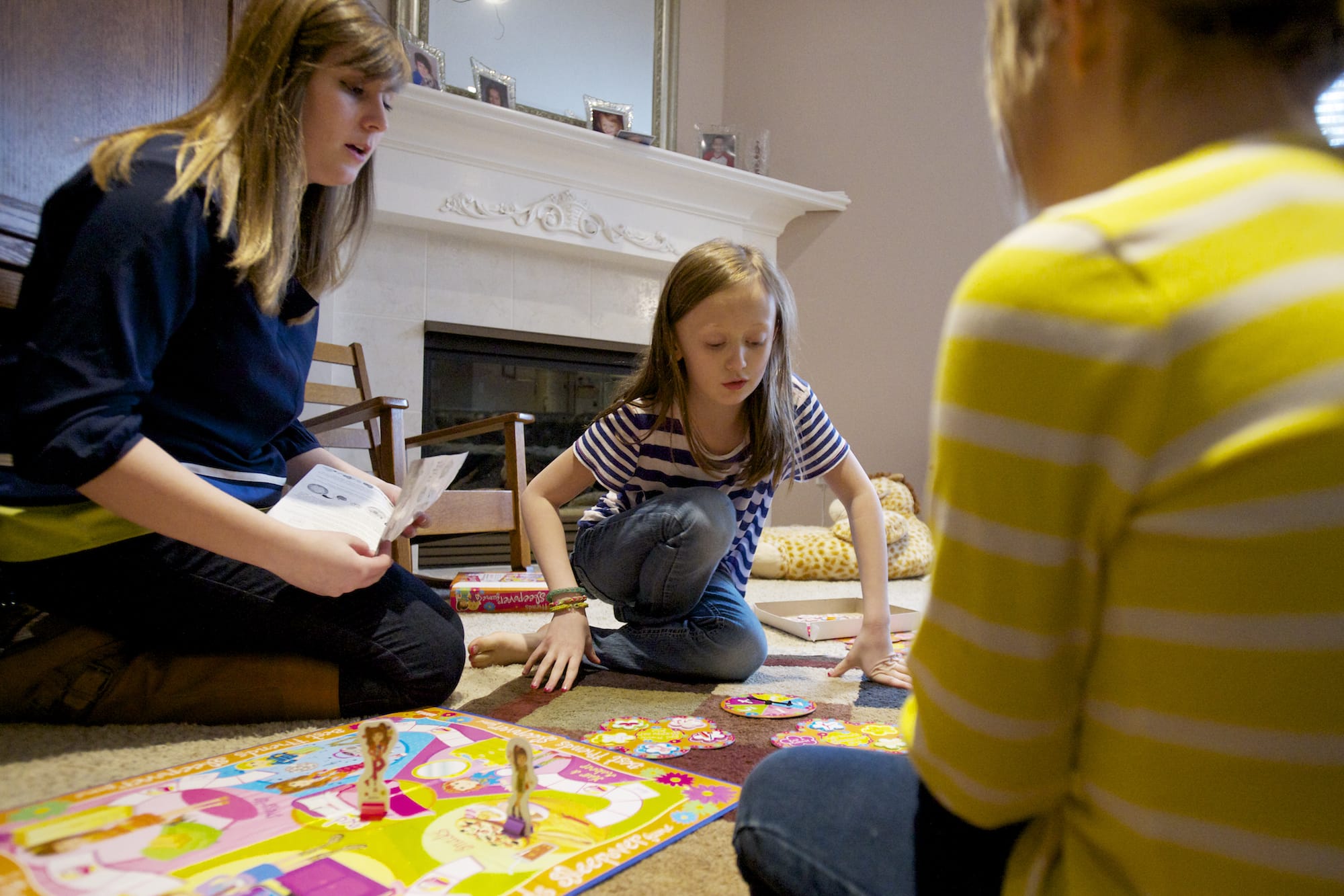 Kelly Slauson, 20, plays a game with Greta Brown, center, a child she cares for in Camas.