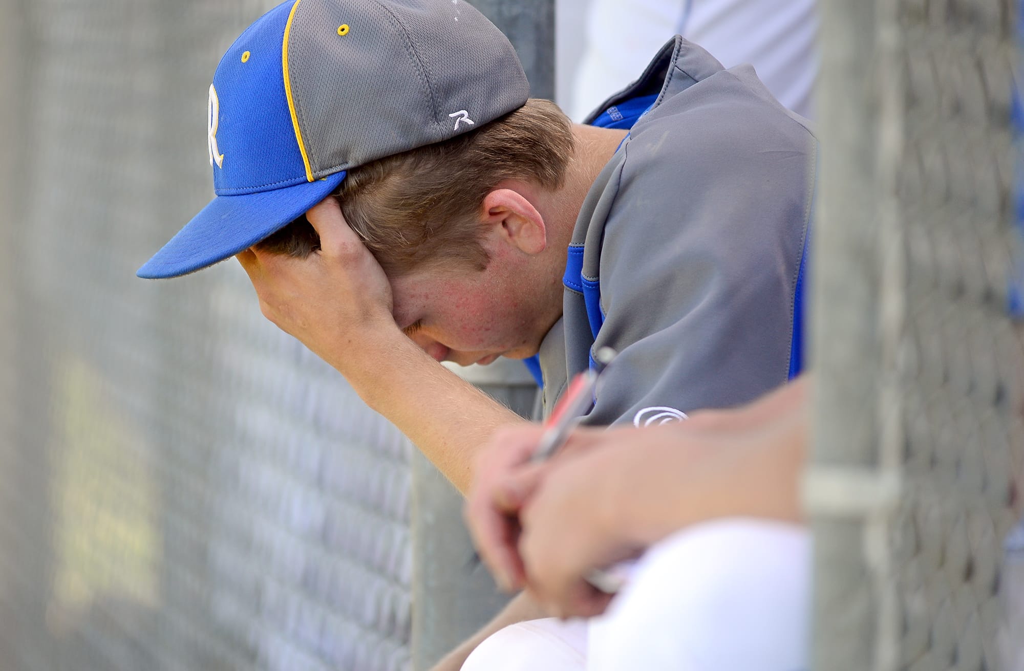 In this photo taken Tuesday, May 13, 2014, Rochester High School pitcher Dylan Fosnacht rests between the 13th and 14th inning of a District IV 1A baseball tournament first-round game against La Center, at Rochester High School in Rochester, Wash. Fosnacht threw 194 pitches as he took a shutout into the 15th inning. His team beat La Center 1-0 in 17 innings.