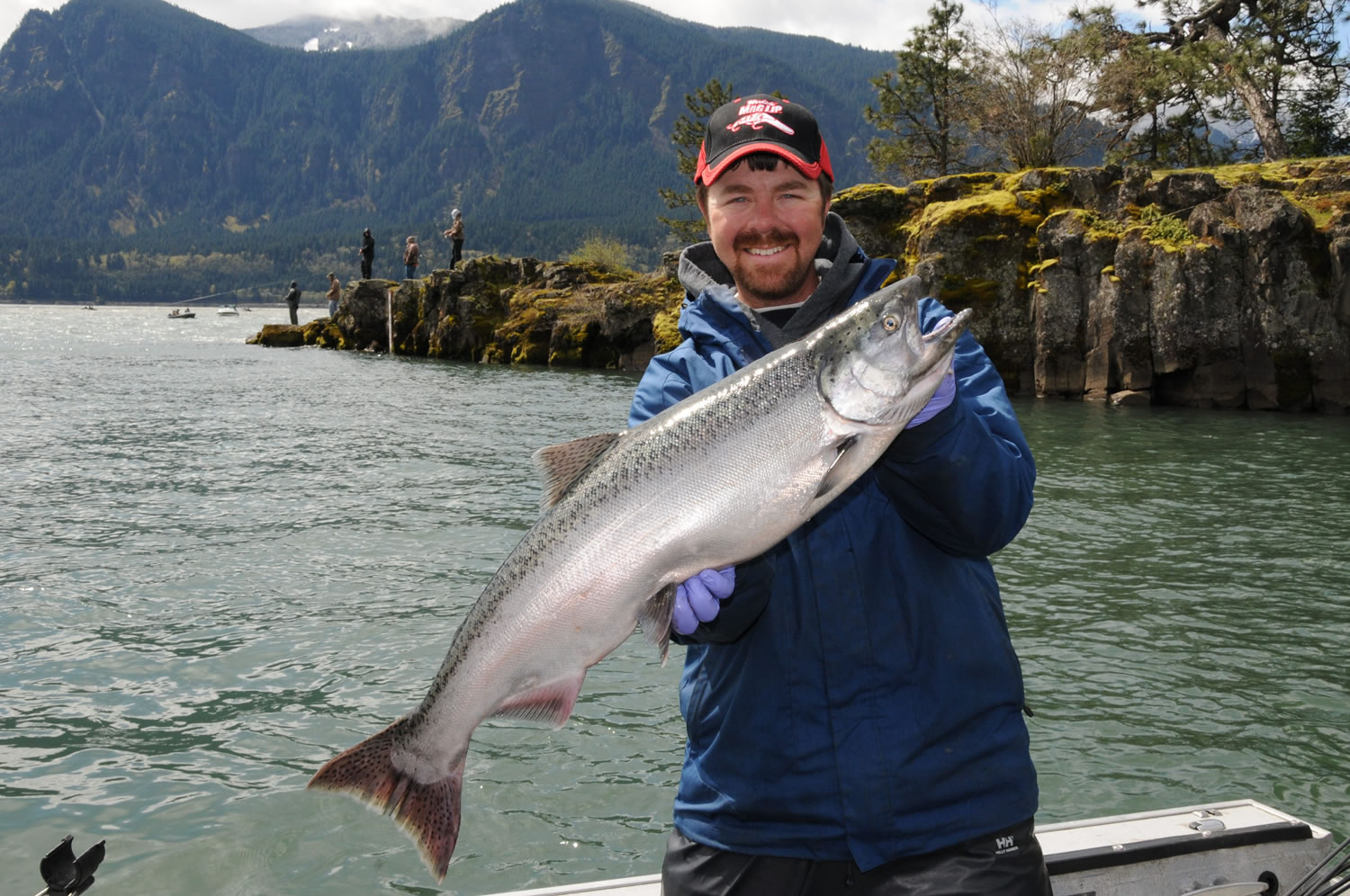 Guide Shane Magnuson poses with a spring chinook caught at the mouth of Wind River in Skamania County.