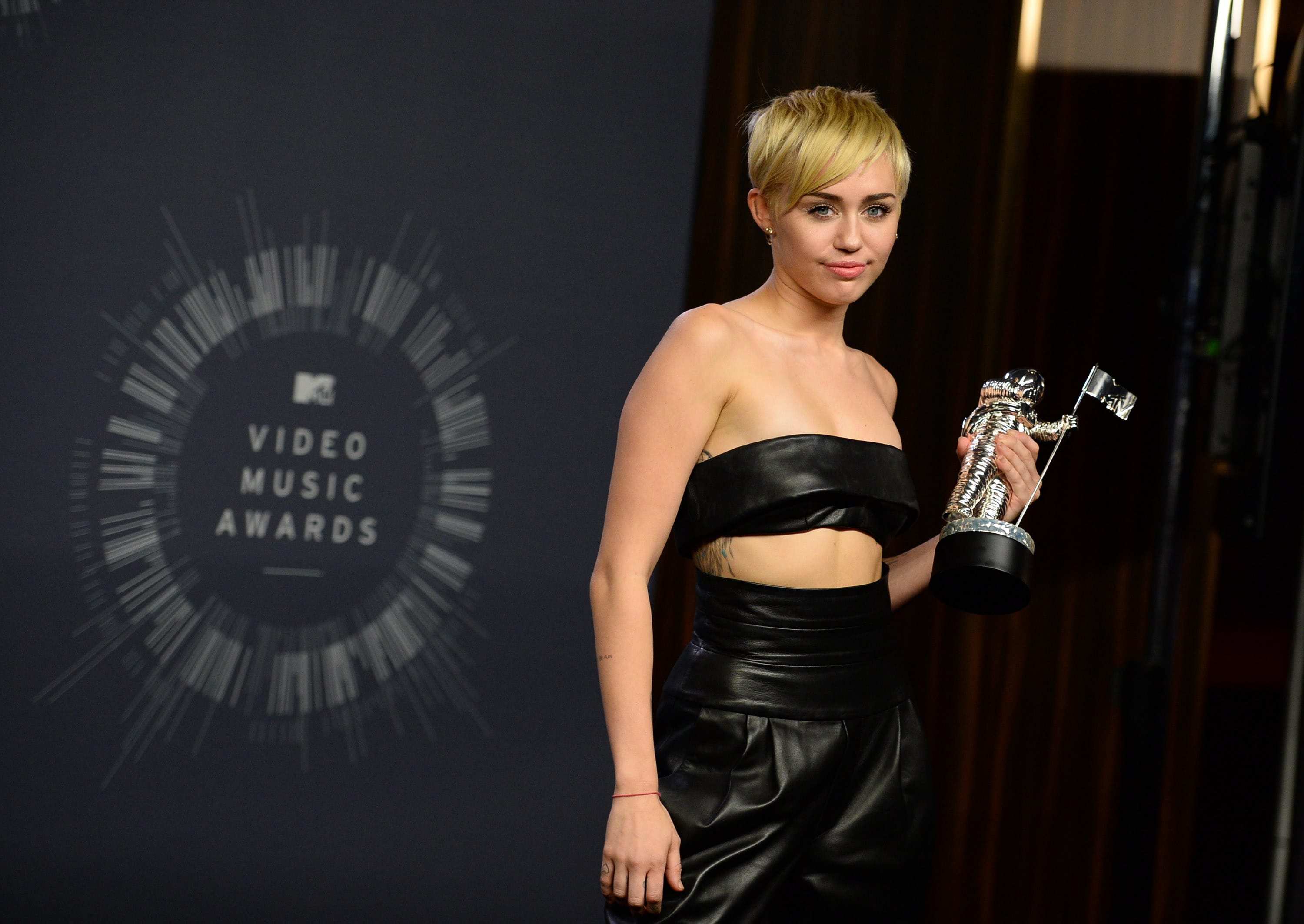 Miley Cyrus poses with the award for Video of the Year in the press room at the MTV Video Music Awards at The Forum on Sunday in Inglewood, Calif.