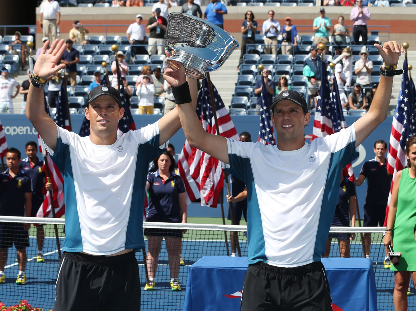 Bob, left, and Mike Bryan raise the men's doubles championship trophy after defeating Marc Lopez and Marcel Granollers, of Spain, in the doubles championship match of the 2014 U.S. Open tennis tournament, Sunday, Sept. 7, 2014, in New York. The win gave the Bryan's their 100th tournament title.