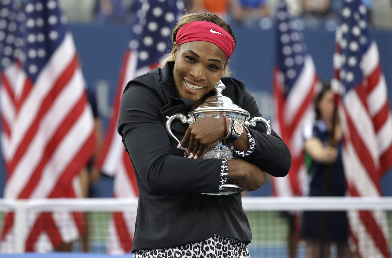 Serena Williams, of the United States, hugs the championship trophy after defeating Caroline Wozniacki, of Denmark, during the championship match of the 2014 U.S. Open tennis tournament, Sunday, Sept. 7, 2014, in New York.