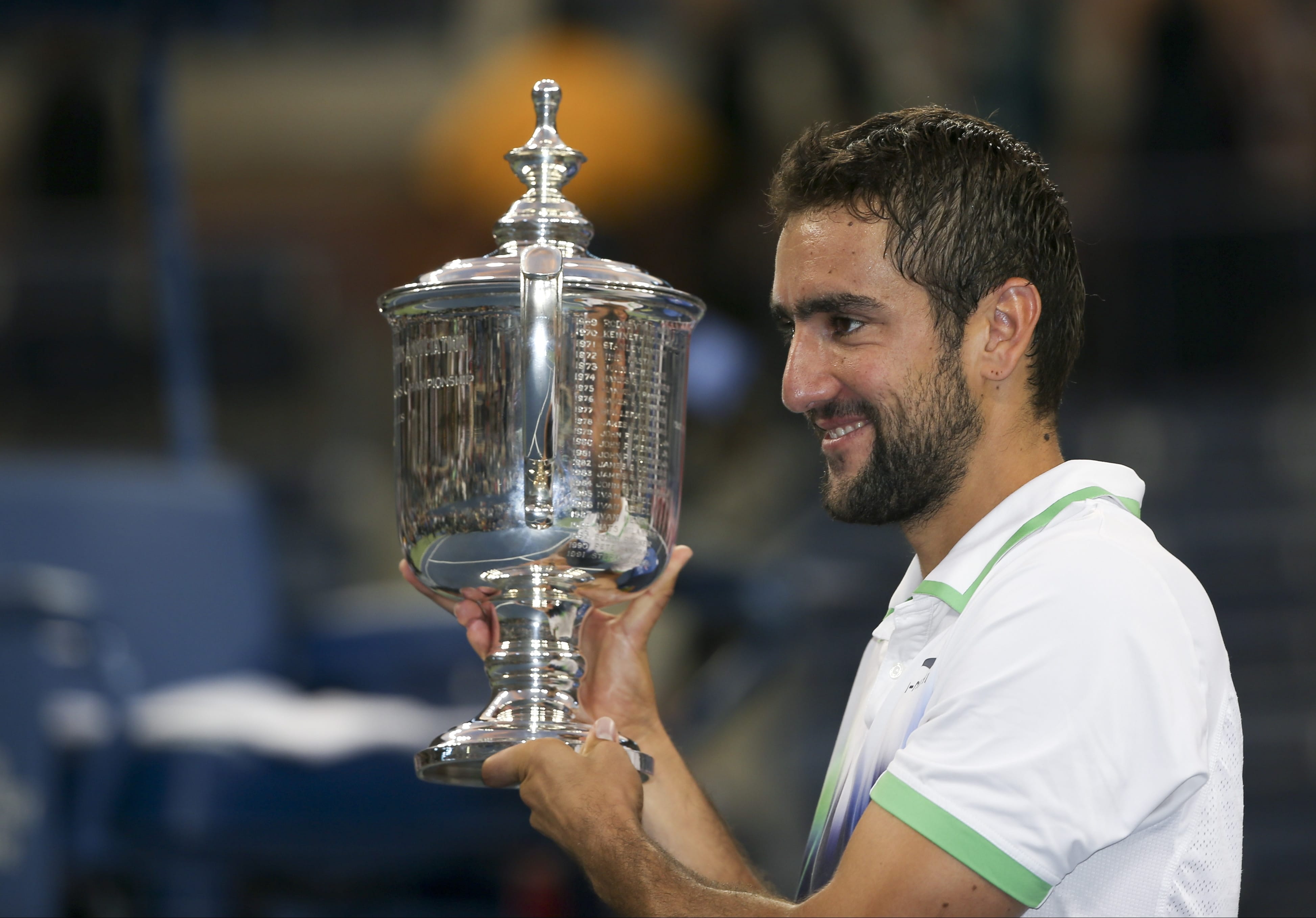 Marin Cilic, of Croatia, holds up the championship trophy after defeating Kei Nishikori, of Japan, in the championship match of the 2014 U.S. Open tennis tournament, Monday, Sept. 8, 2014, in New York.