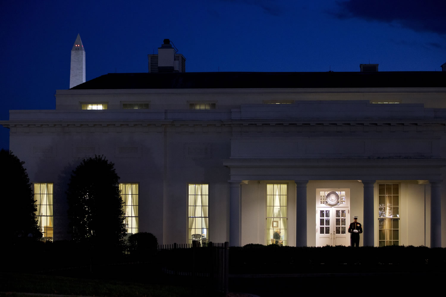 A Marine stands guard outside the West Wing of the White House in Washington, signifying that President Barack Obama is working inside.