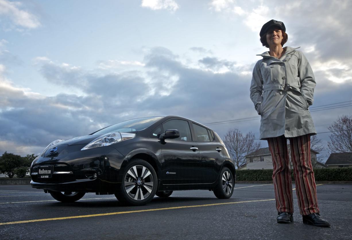 Jo Roberts poses for a portrait next to her Nissan Leaf on March 27 at Pacific Middle School in Vancouver.