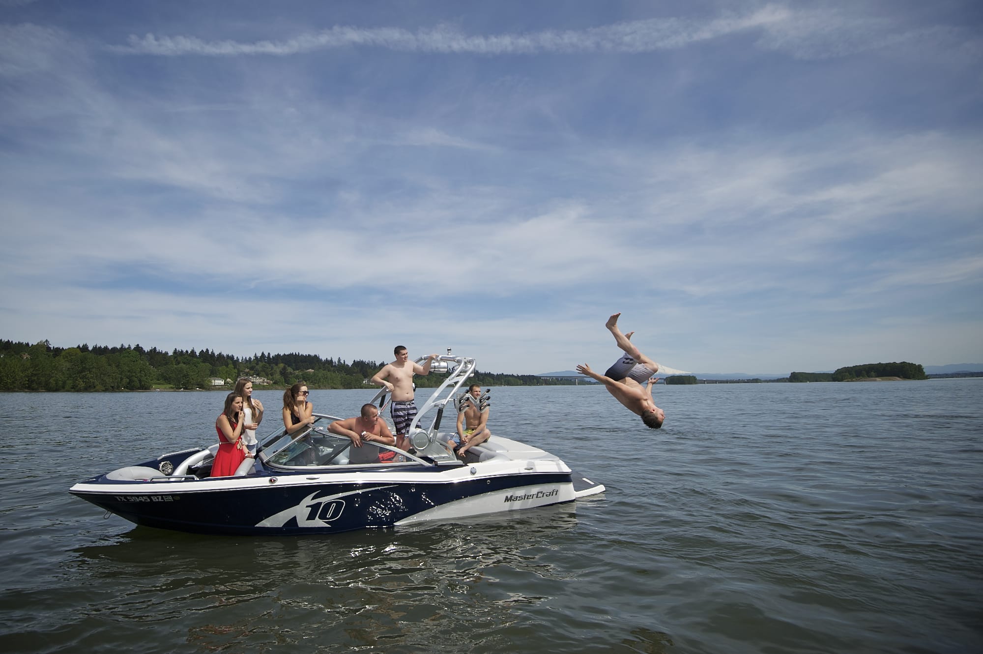 Oleg Babiy, 22, of Portland does a back flip off the back of a boat that was stopped on the Columbia River by the Clark County Sheriff's marine patrol boat for having out-of-state registration.