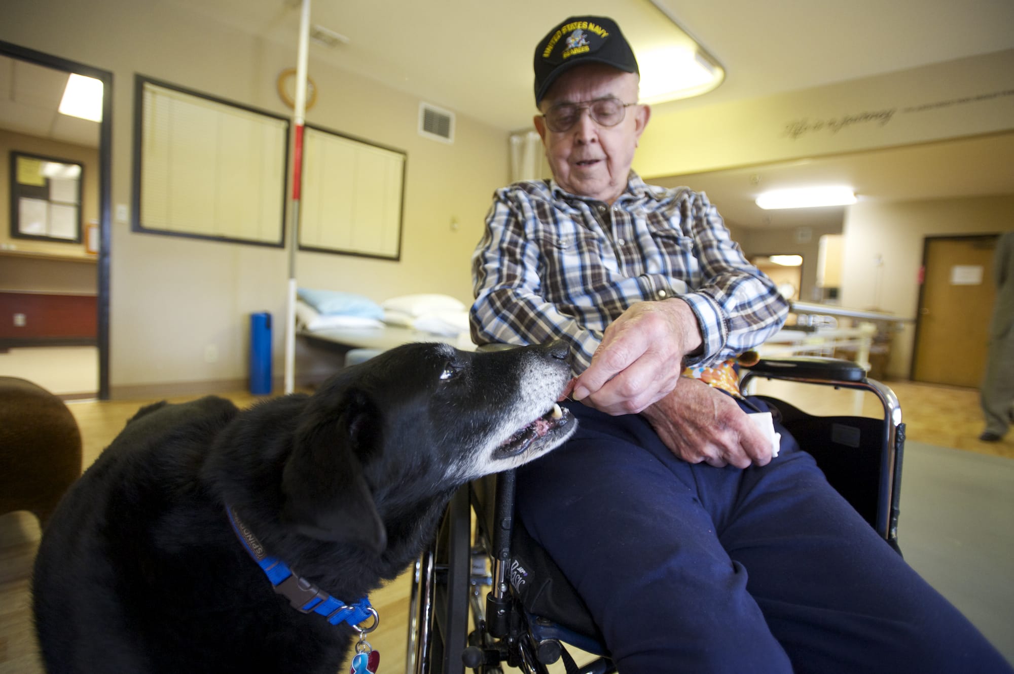 Oswald Kaul, 92, of Vancouver feeds Luke, a therapy dog at Fort Vancouver Convalescent Center.