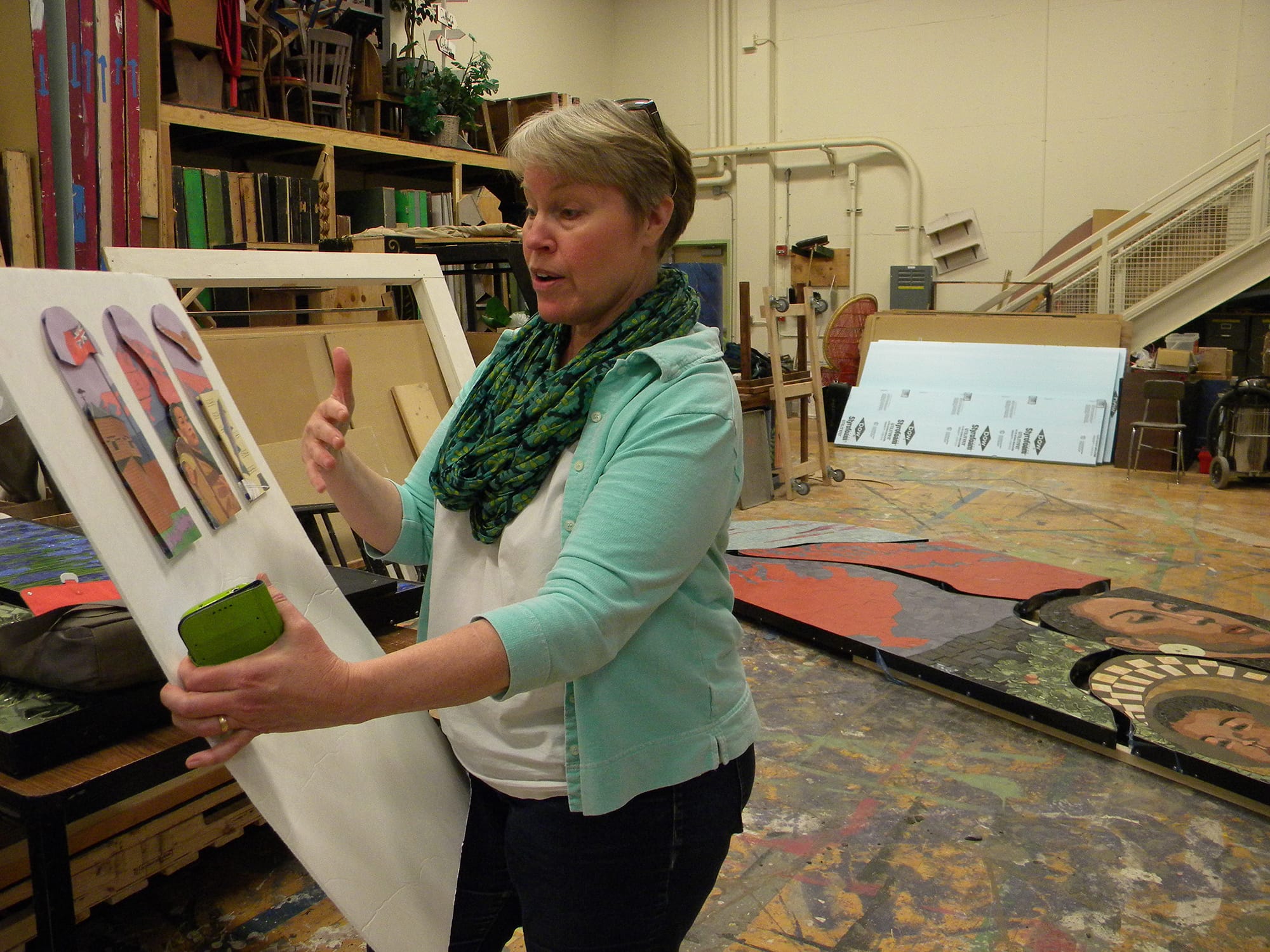 Jeri Swatosh, a Vancouver School of Arts and Academics teacher who has directed the 10-year Confluence Project, holds the drawings for one of the triptychs.