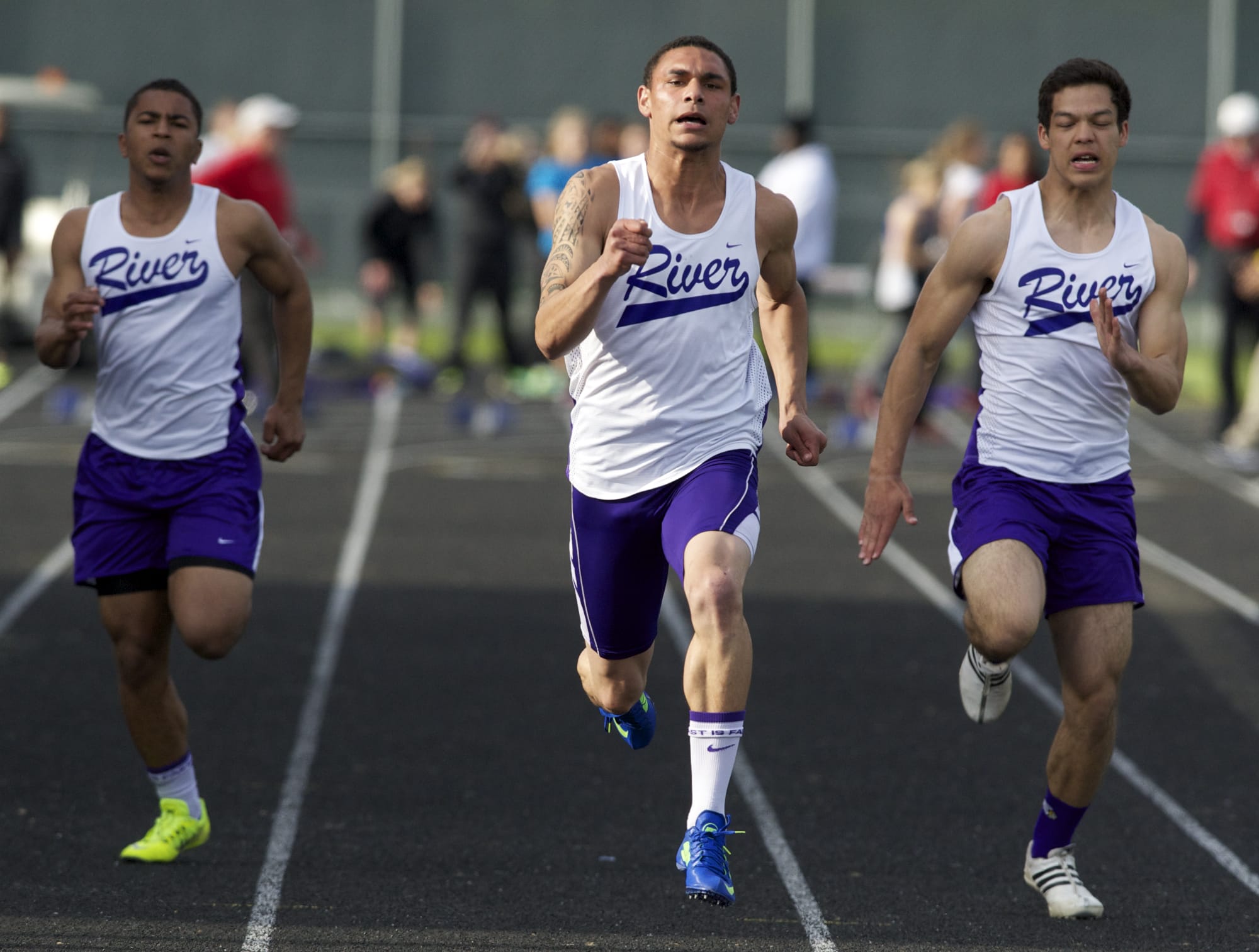 Columbia River's Marcus Gaylor, center, on his way to victory in 100 meters on Friday at the John Ingram Twilight Meet.