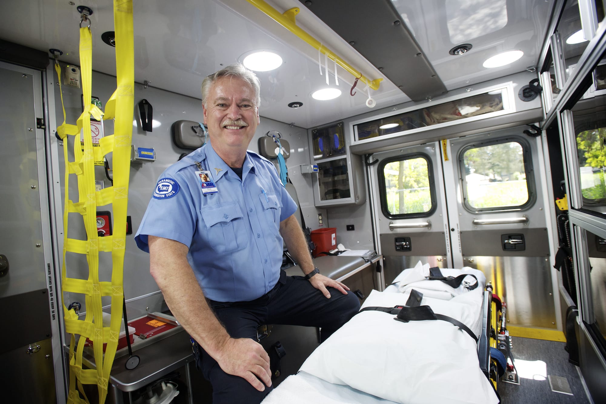 American Medical Response paramedic Rick Futrell sits inside an ambulance.