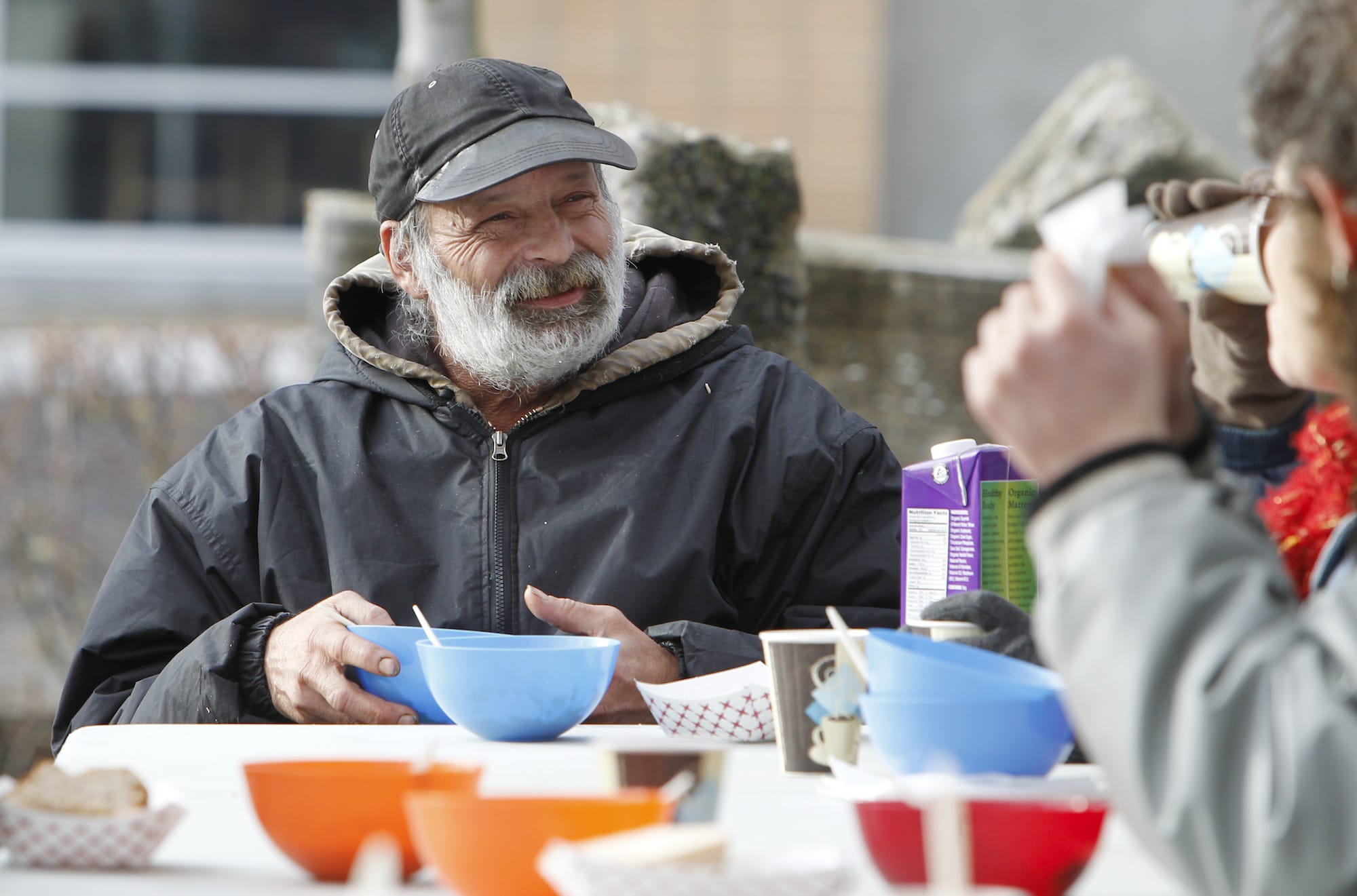 Joe Lukowiak, a homeless Vancouver man, eats and chats Sunday afternoon at the Stone Soup Community Meal in Turtle Place Park.