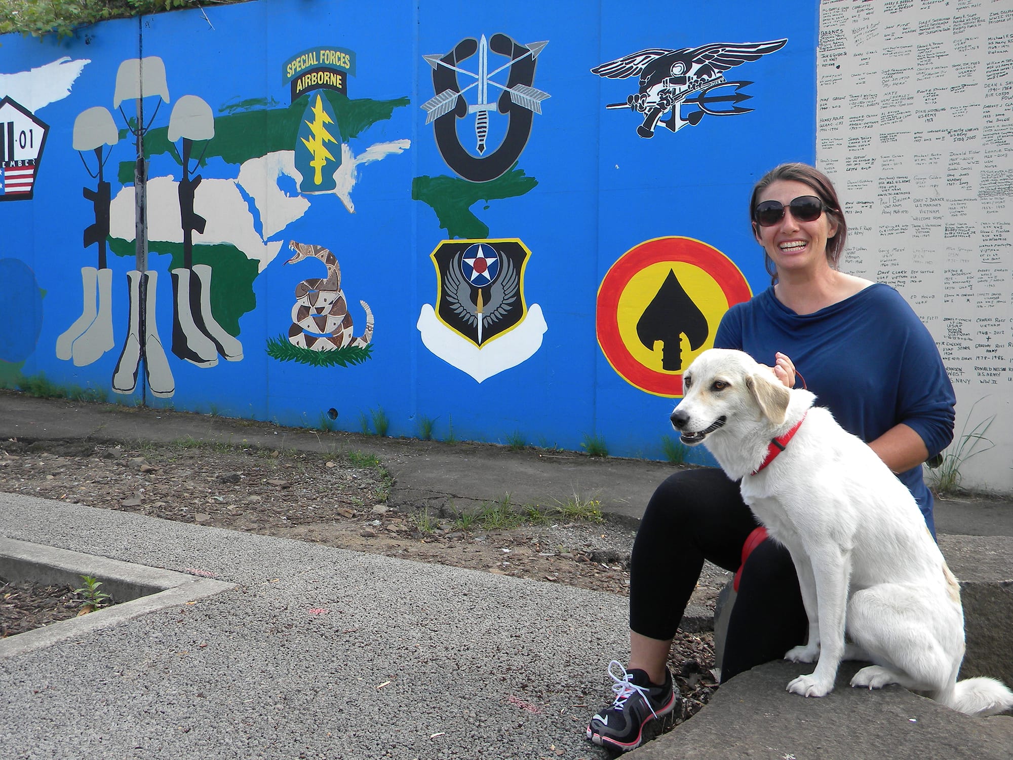 Olympia Yarger and Snicklefritz, who was with her husband's team in Afghanistan, stop during their cross-country trip to visit the segment of Vancouver's Remembrance Wall dedicated to current military operations.