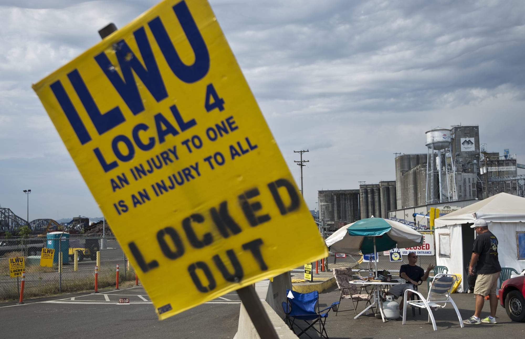 ILWU Local 4 members remain outside the United Grain terminal, on Tuesday August 12, 2014, after word of a tentative agreement has surfaced.