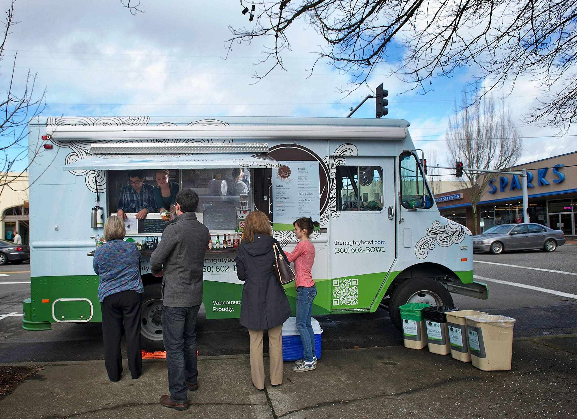 Customers visit the Mighty Bowl food truck in downtown Vancouver during the lunch rush Wednesday.