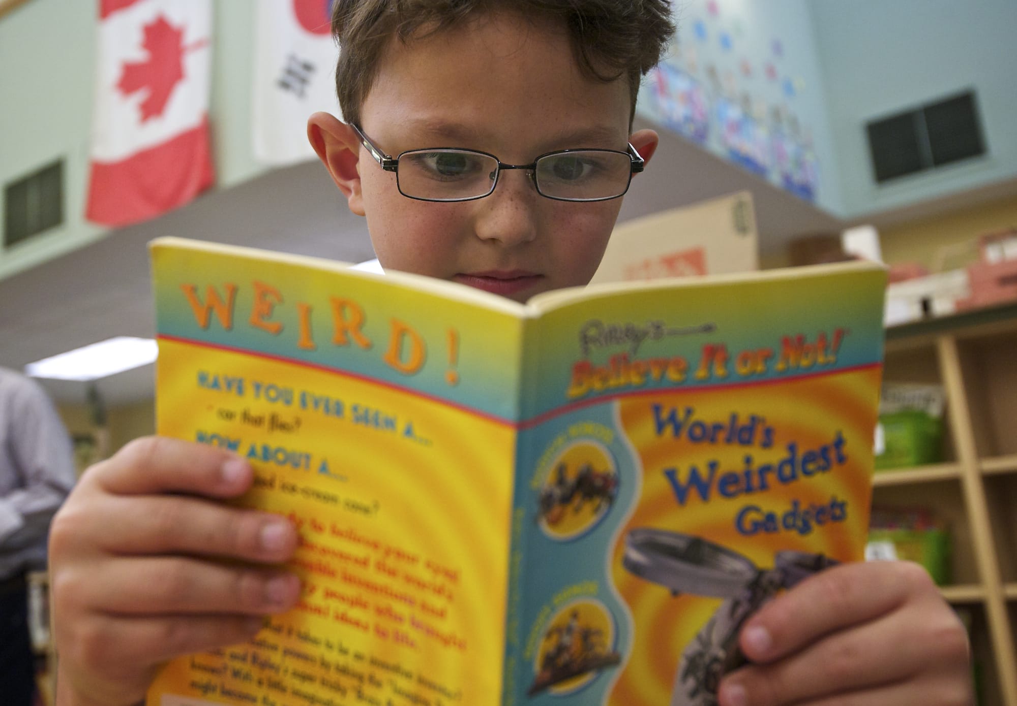 Fruit Valley Community Learning Center fourth-grader Anubis Bicknell-Farrar, 9, chose &quot;Ripley's Believe It or Not! World's Weirdest Gadgets&quot; as one of two books he was given Friday by Goodwill's Book of My Own program. A section in the book about robots got Anubis fired up.