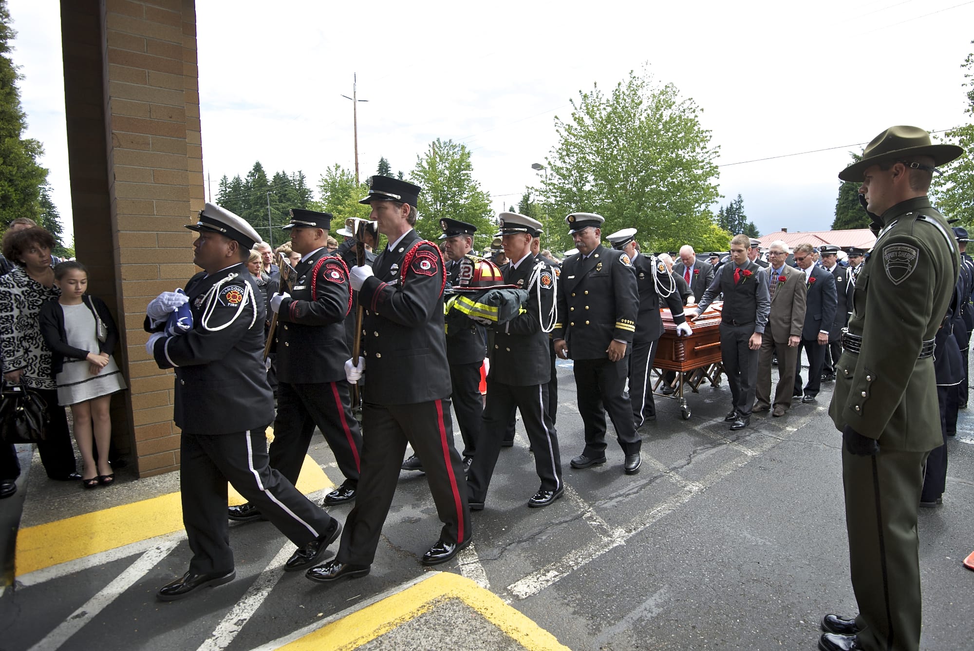 The procession makes its way into the First Church of God on Monday during the funeral for Vancouver Fire Capt.