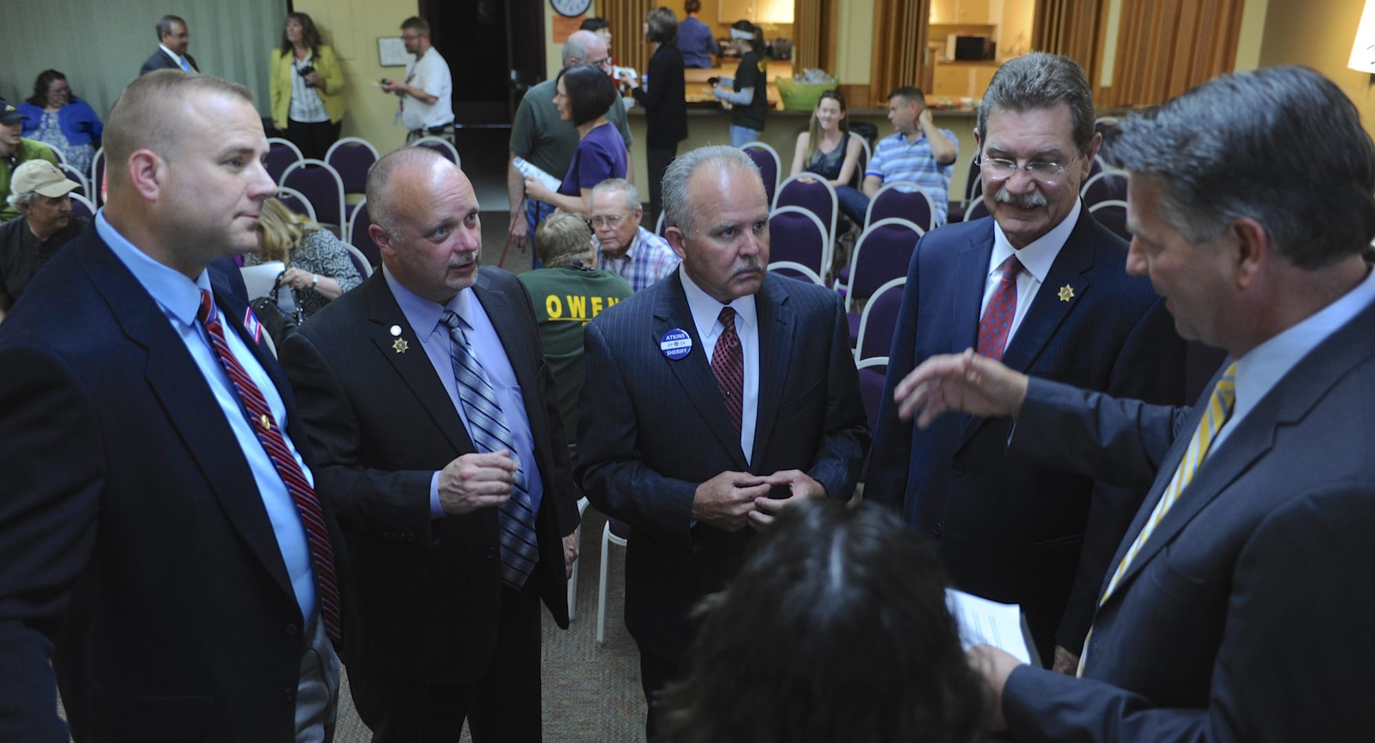 Sheriff candidates Shane Gardner, from left, Ed Owens, Chuck Atkins and John Graser go over the speaking rules prior to a forum Thursday in Vancouver.