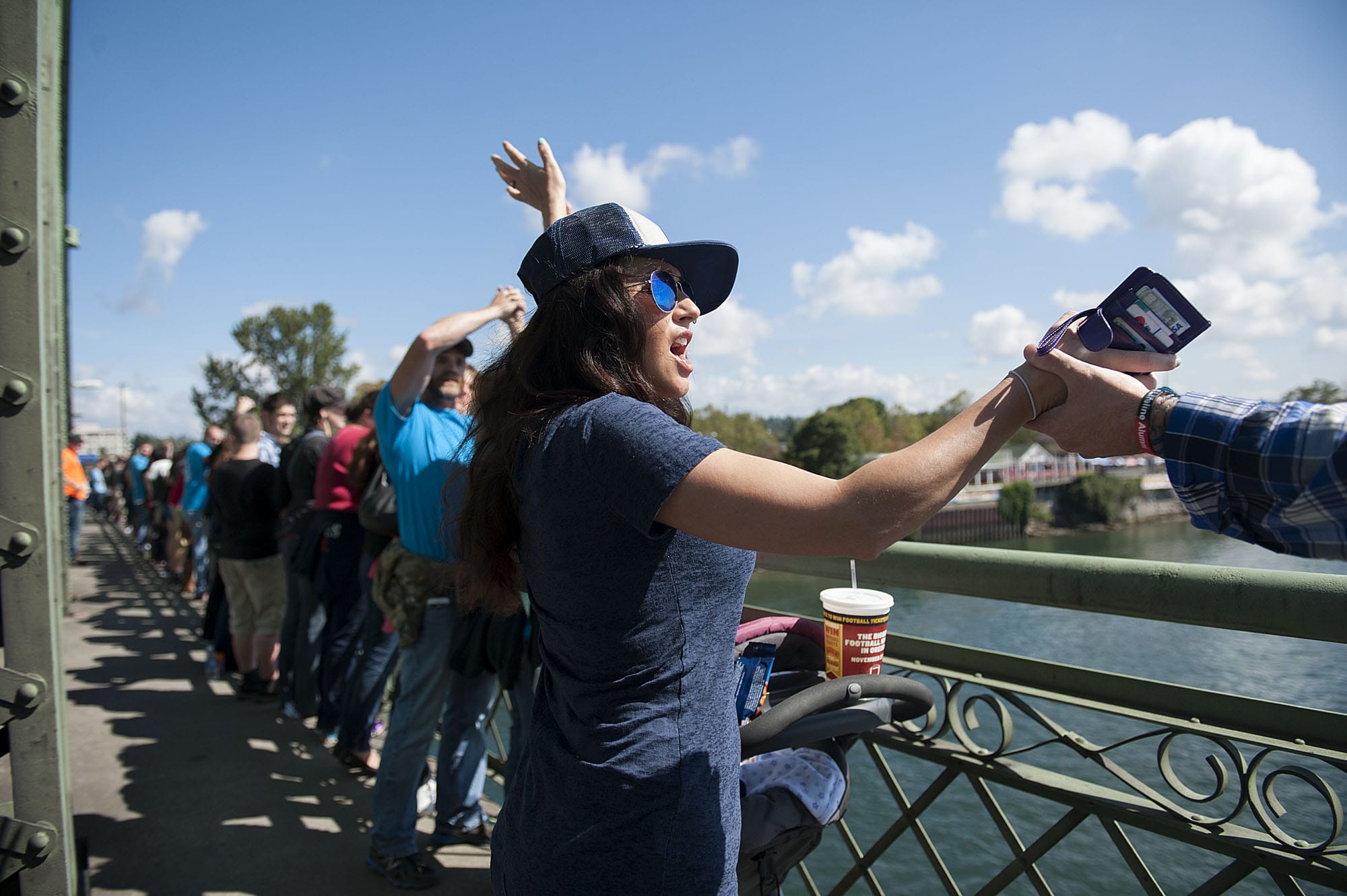 Vanessa McKnight, center, of Vancouver celebrates almost five years of sobriety while joining other participants on the Interstate Bridge during the Hands Across the Bridge event Monday afternoon, Sept. 7, 2015.