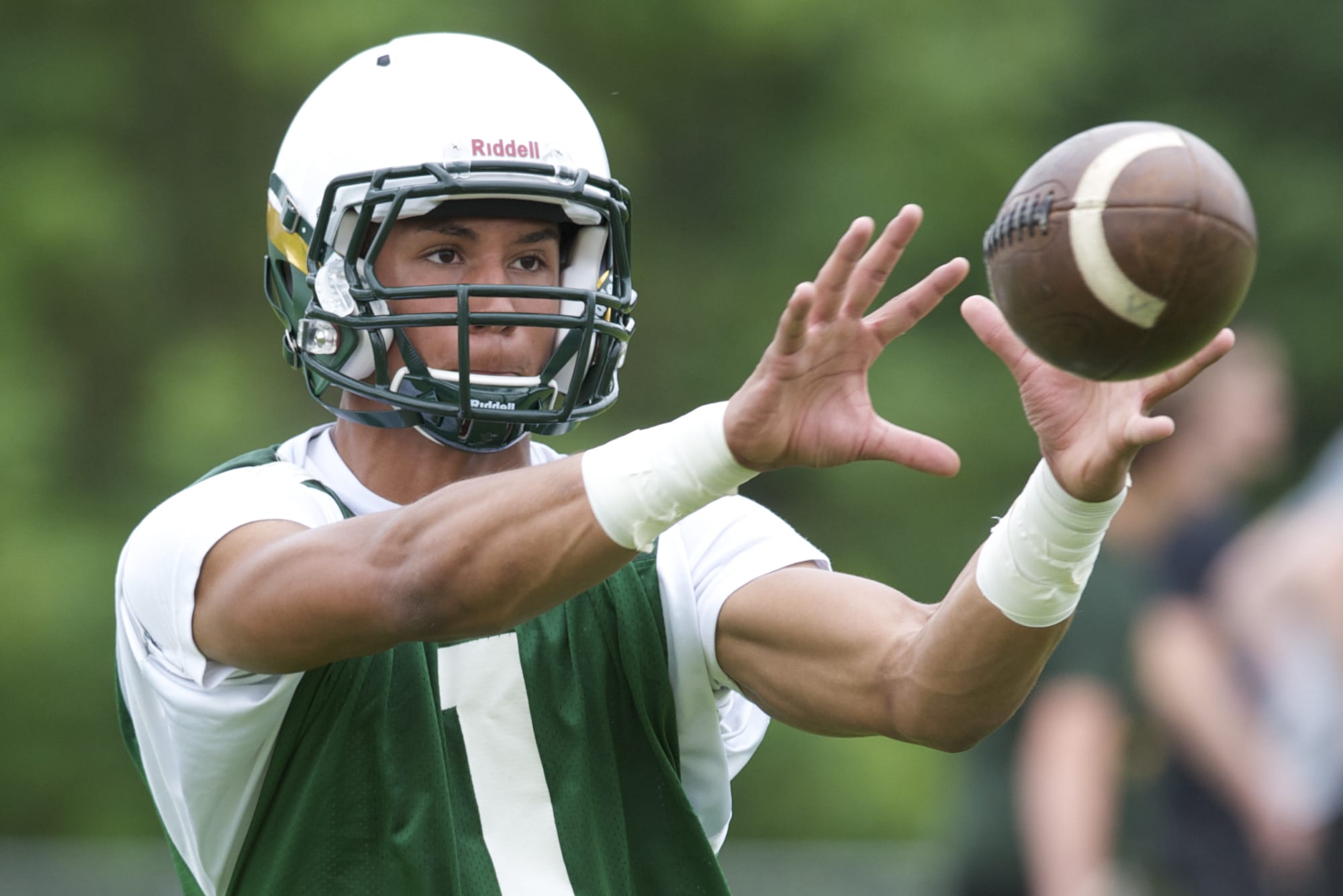 Evergreen receiver  Justice Murphy participates in spring football practice on Tuesday at McKenzie Stadium.
