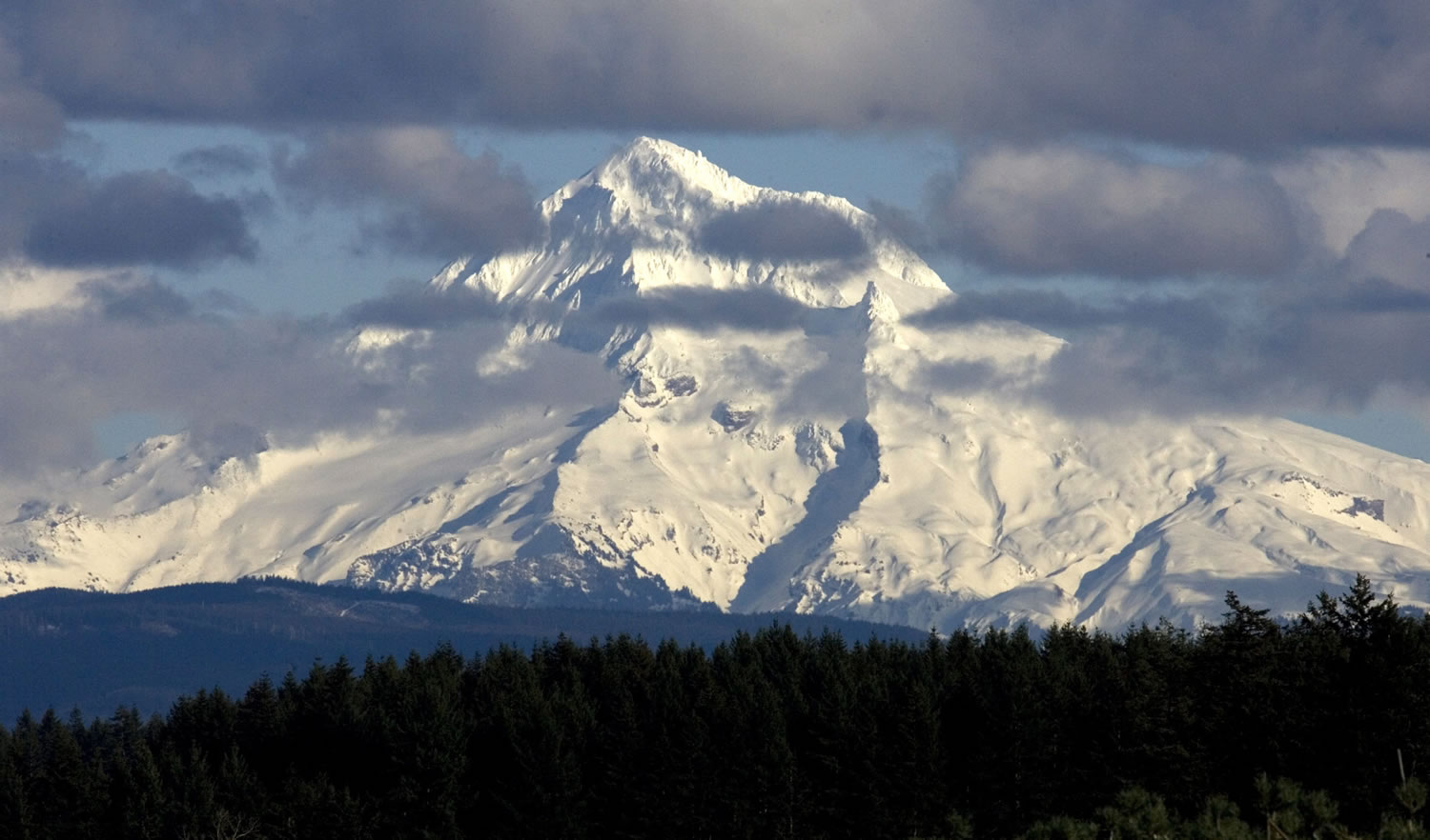 Clouds flit across the west face of Mount Hood as seen near Boring, Ore., in February 2010.