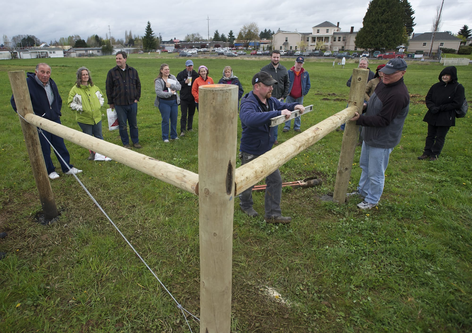 Trevor Prothero, center right, of Wilco farm supply uses a level to check a post while leading a fence-building class last month at the ninth annual Small Acreage Expo at 78th Street Heritage Farm. New federal data show that while total acreage and farms were in decline in Clark County, the number of farms working 9 acres or less grew significantly.
