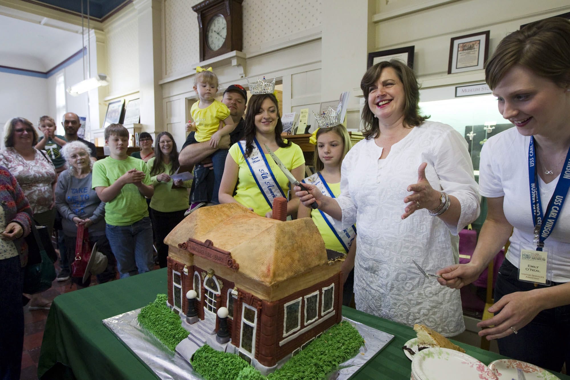 Outgoing Clark County Historical Museum Executive Director Susan Tissot cuts a cake created in the likeness of the museum to celebrate the 50th anniversary of its dedication.