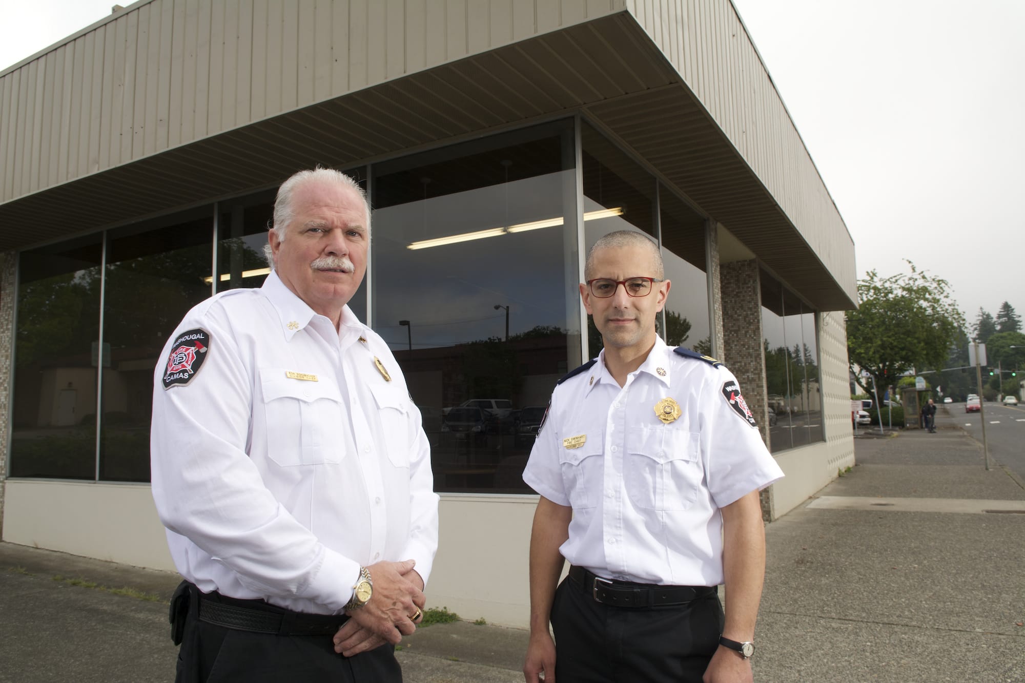 Camas-Washougal Fire Chief Nick Swinhart, right, and Fire Marshal Ron Schumacher pause on a busy moving day outside of the department's new fire marshal's office at Northeast Everett Street and Third Avenue.