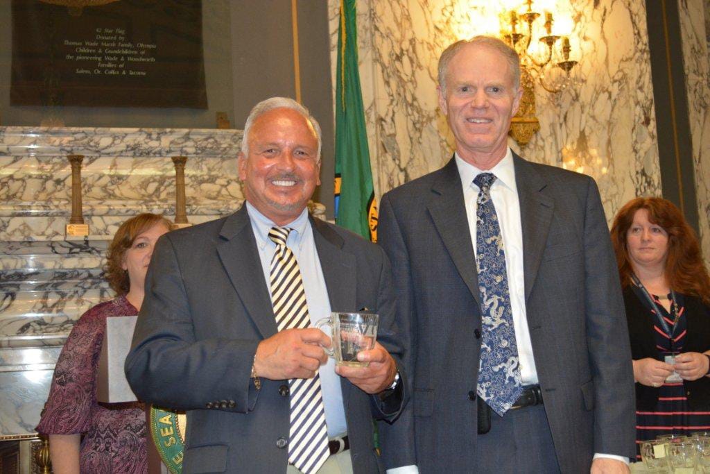 Harney Heights: Bill Allman, left, receives the an award from VA administrator Mike Murphy in Olympia.