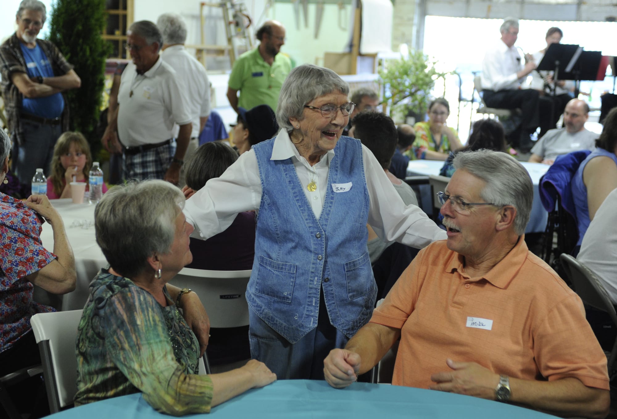 Betty Eves, center, chats with Gayle, left, and Mike Mattson as Friends of the Carpenter celebrates the 10th anniversary of its Friendship Center and thanks its many volunteers.