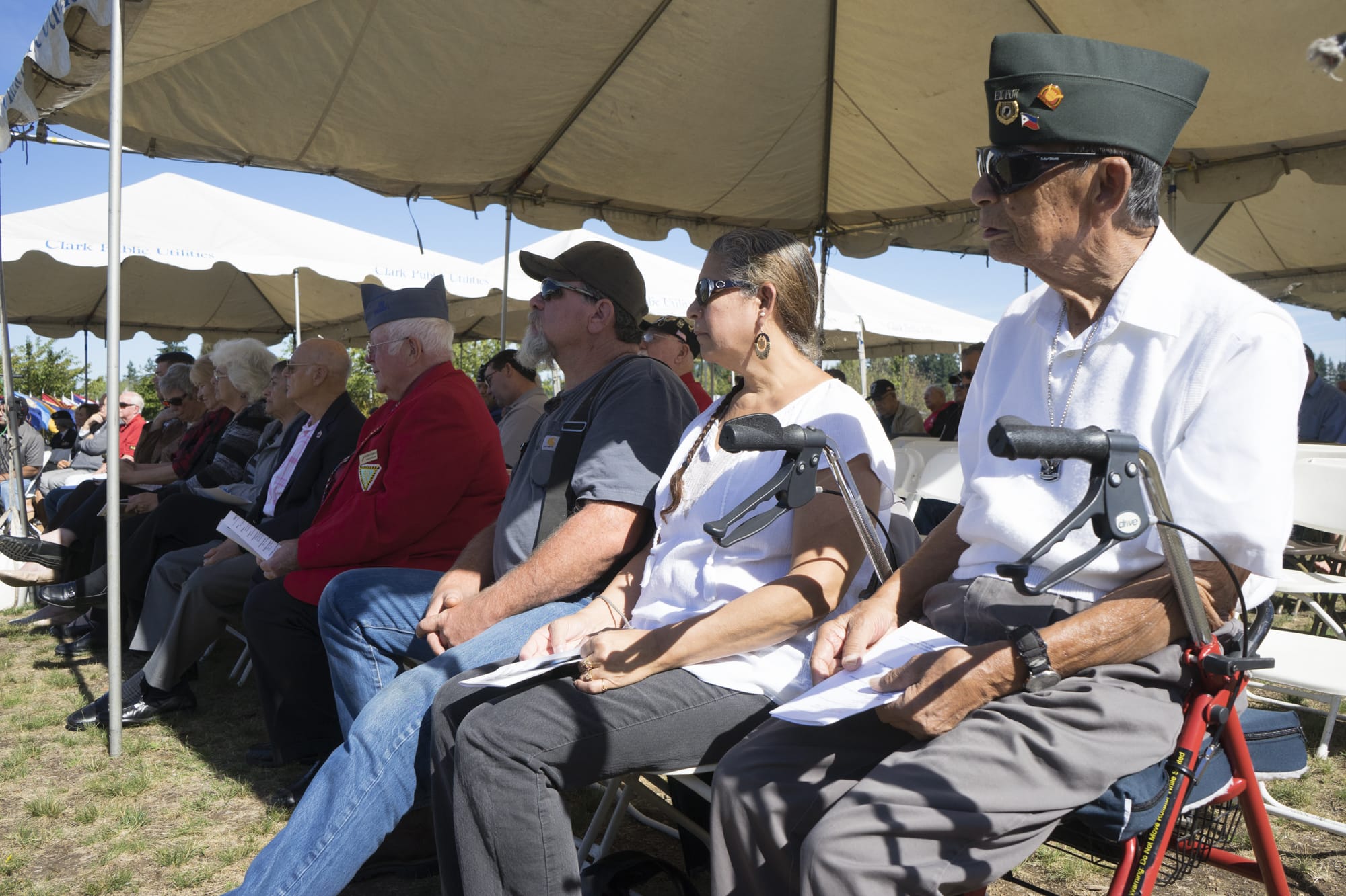 Robert H. Navarette, right, a World War II veteran, listens to speakers at the POW/MIA Recognition Day Observance at the Armed Forces Reserve Center in Vancouver on Saturday, Sept. 19, 2015.