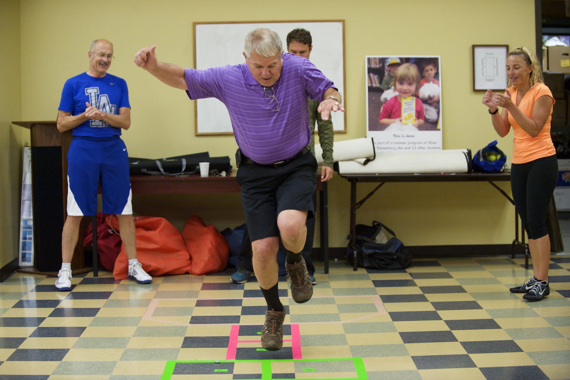 Vancouver City Councilmember Larry Smith competes in a game of Celebrity Hopscotch at the Share Fromhold Service Center as part of the Give More 24 charity event, Thursday, September 18, 2014.