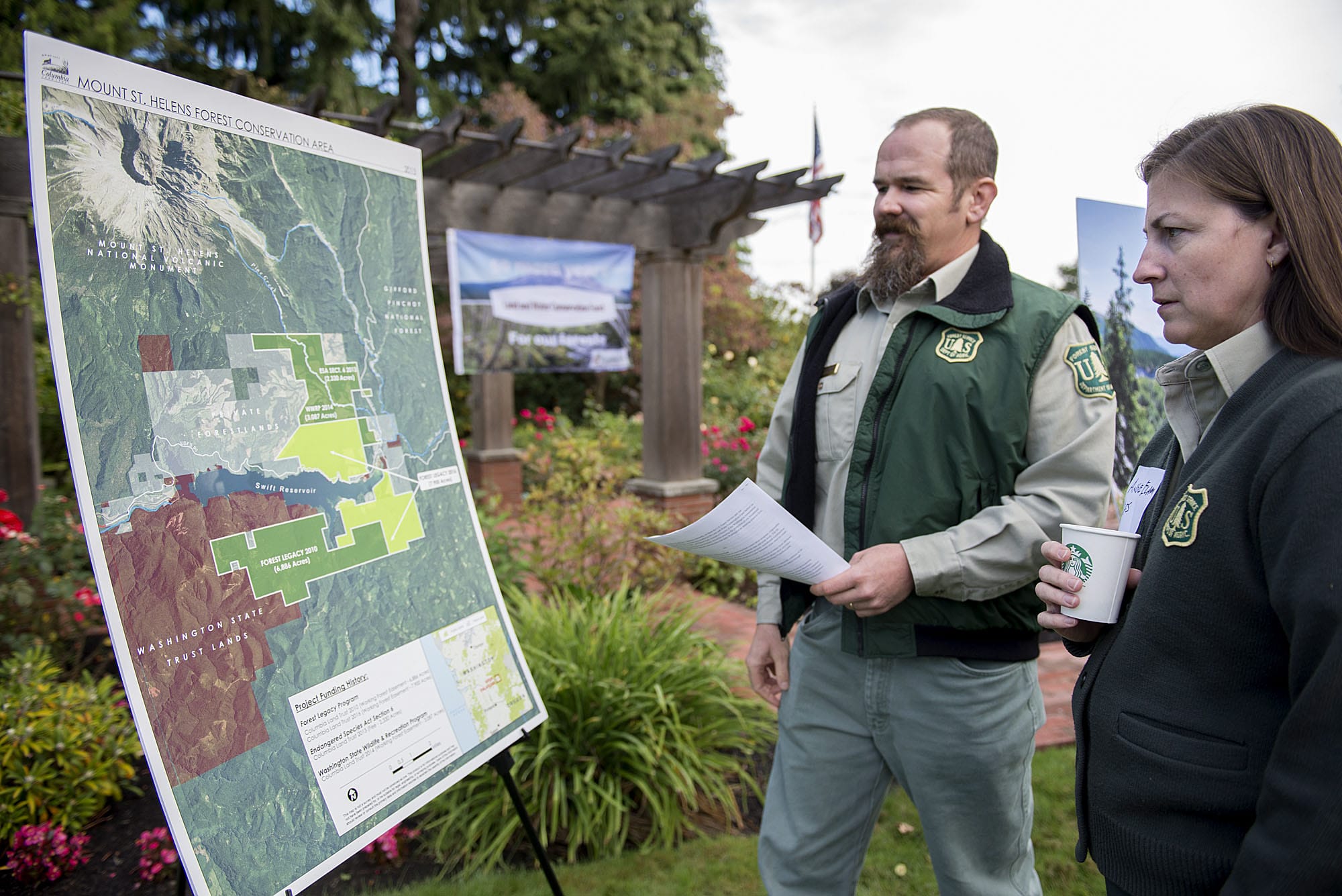 Tedd Huffman, monument manager at the Mount St. Helens National Volcanic Monument, left, and Angie Elam of the Gifford Pinchot National Forest, look over a diagram of the Mount St. Helens Forest Conservation Area on Tuesday morning, Sept. 22, 2015 at the Lynch Residence in Vancouver.