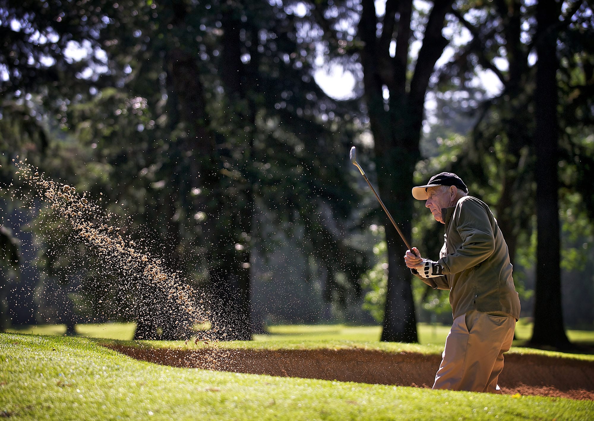 Kent Myers hits out of the sand trap on the 15th hole at Royal Oaks Country Club on Friday June 6, 2014.