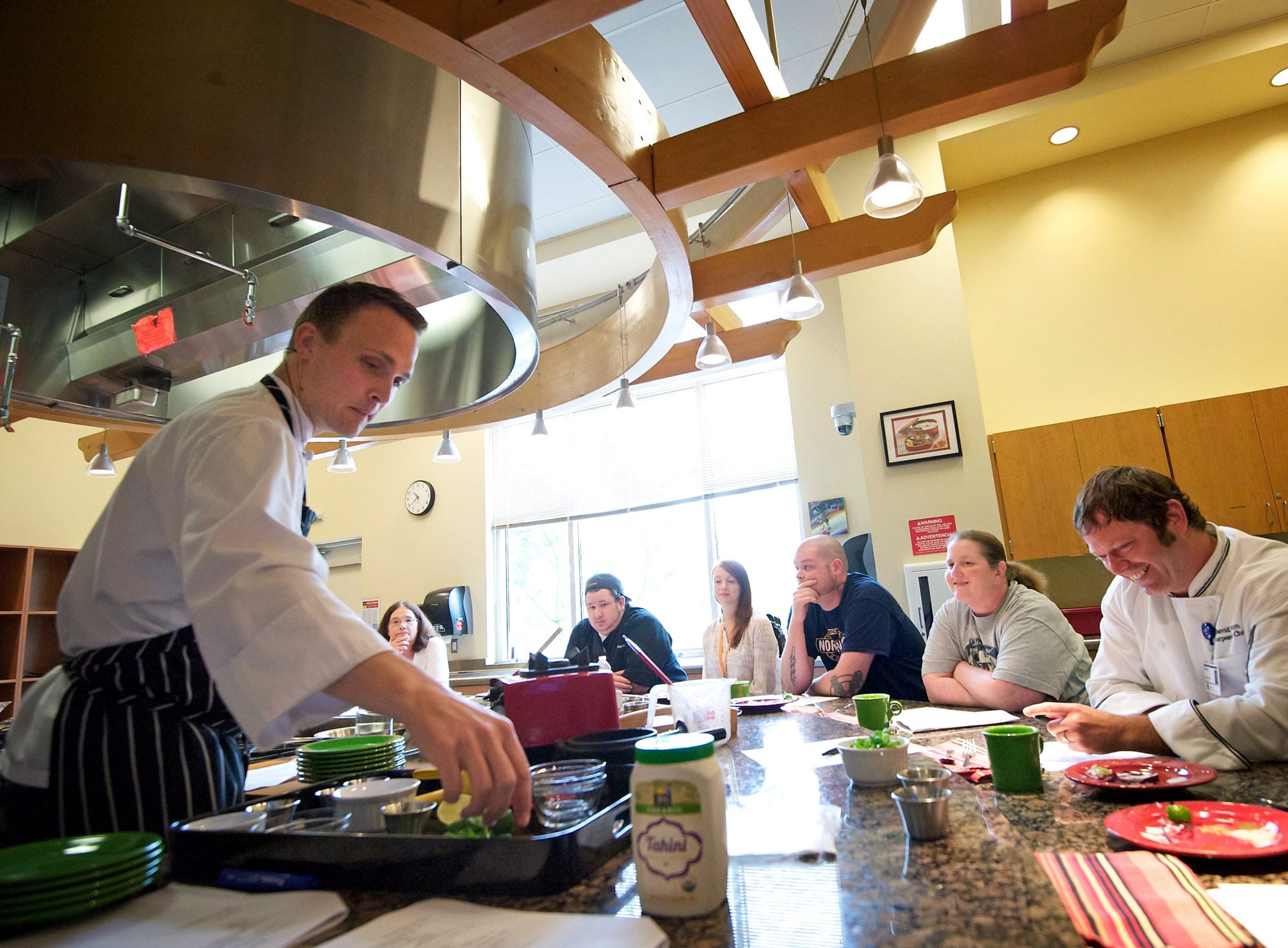 Garrett Berdan, a chef and registered dietitian from Bend, Ore., demonstrates techniques for enhancing the flavors of spices and using more flavorful ingredients during a class for local chefs Wednesday.