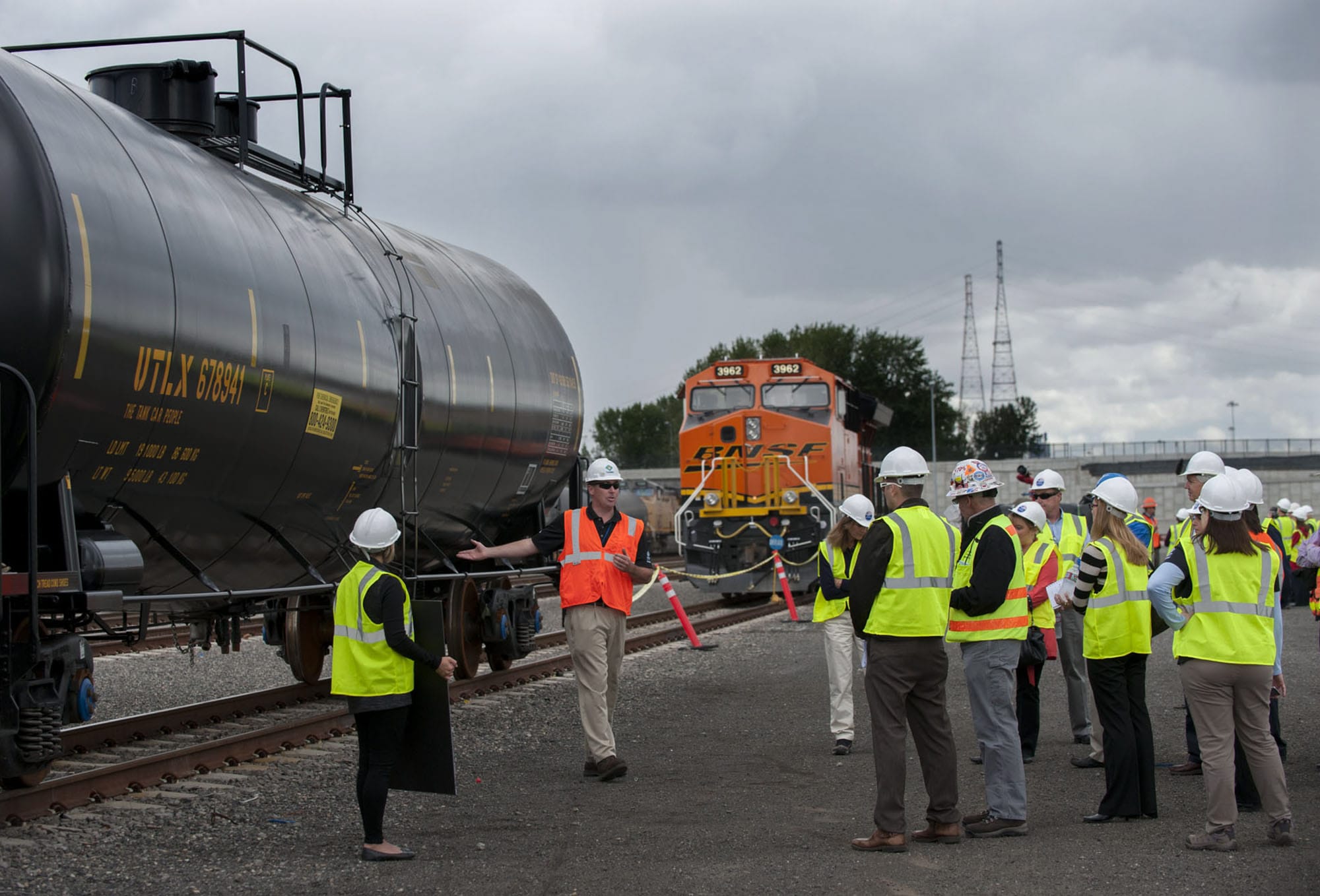John Hack of Tesoro, second from left in orange vest, shares information about tank cars with invited guests at the Port of Vancouver's Terminal 5 on Thursday afternoon, Sept. 17, 2015.
